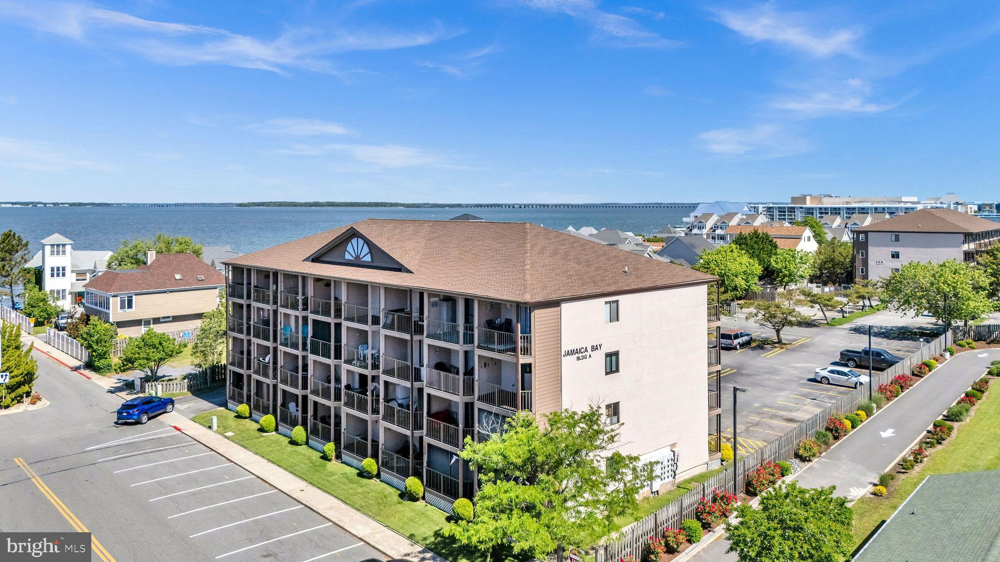 This is the one you've been waiting for! Welcome to your dream coastal retreat at Jamaica Bay! This adorable 1-bedroom, 1-bathroom condo offers stunning top-floor views with a peek of the bay and the perfect blend of style and location. The gorgeous kitchen features a new fridge, stove, and microwave, complemented by beautifully resurfaced cabinets and a breakfast bar with seating that opens to a bright and airy living room. Step out onto your private balcony and soak in the coastal breeze — the ideal place to relax after a day of Ocean City fun. Enjoy the convenience of a new washer and dryer, along with updated flooring throughout the unit. Whether you're looking for a serene personal getaway or a fantastic rental investment, this condo delivers. Located just a short distance from the bay, beach, boardwalk, Jolly Roger Amusement Park, Barn 34, Tony Luke’s, and many more local favorites, this prime property won’t last long. Don’t miss your chance to own a slice of paradise!