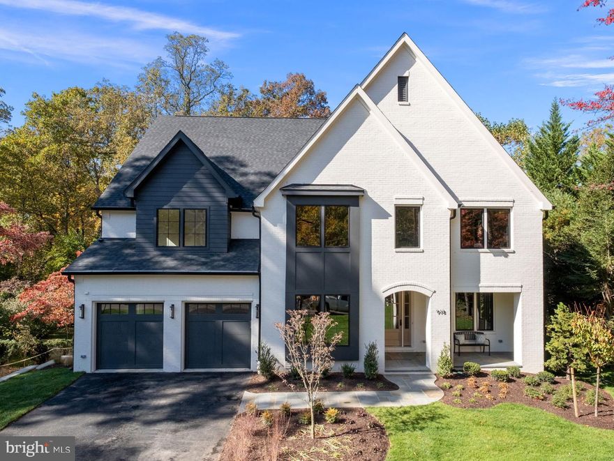 Welcome to the epitome of contemporary living in the heart of McLean's prestigious Langley Forest neighborhood.  Situated high on the exclusive Mackall Avenue and minutes from Langley High School, McLean based Focal Point Homes proudly presents this brand-new Transitional English Cottage Style home that marries classic charm with modern elegance.   With thoughtful details at every glance, this home features over 8,000 feet on 5 finished levels, 4-sided painted brick exterior, a 28’ depth oversized garage, functional elevator and a 22’x33’ indoor sports court with adjustable height basketball hoop.  The kitchen is a work of art with elegant Shiloh cabinetry, a 12’ Cambria Inverness Frost Quartz waterfall island, 60” column panelized refrigerator/freezer, double dishwasher and La Cornue CornuFé Matte Black freestanding range.  Adjacent to the kitchen are the spacious informal dinning and family room area that features elegant lighting, a custom wood ceiling feature and Anderson 400 series casement windows, perfect for taking in picturesque views of the private half acre walk-out lot. Other features not to be missed on the main level include the covered screened rear porch, Sonos built-in speaker system, custom built bookshelves in the private study, butlers pantry complete with 92 bottle capacity Thermador wine column and the intimate dining room designed for large family gatherings or entertaining with friends.  The second level features 3 spacious secondary bedrooms all with walk-in closets and ensuite baths, an open loft area and the owners suite with vaulted ceilings, custom closets and walk-in shower with dual Brizo Odin Luxe Gold rain heads.  The finished attic level also features a loft, bedroom, bathroom and windows overlooking the treetops of the yard below.  Finally, the basement area is the perfect gathering space for all ages with the rec room and wetbar overlooking the sports court and walkout access to the manicured back yard. Whether you're looking for a quiet retreat or a space to entertain and impress, this home has it all. Don't miss your chance to call this one of a kind home your own!