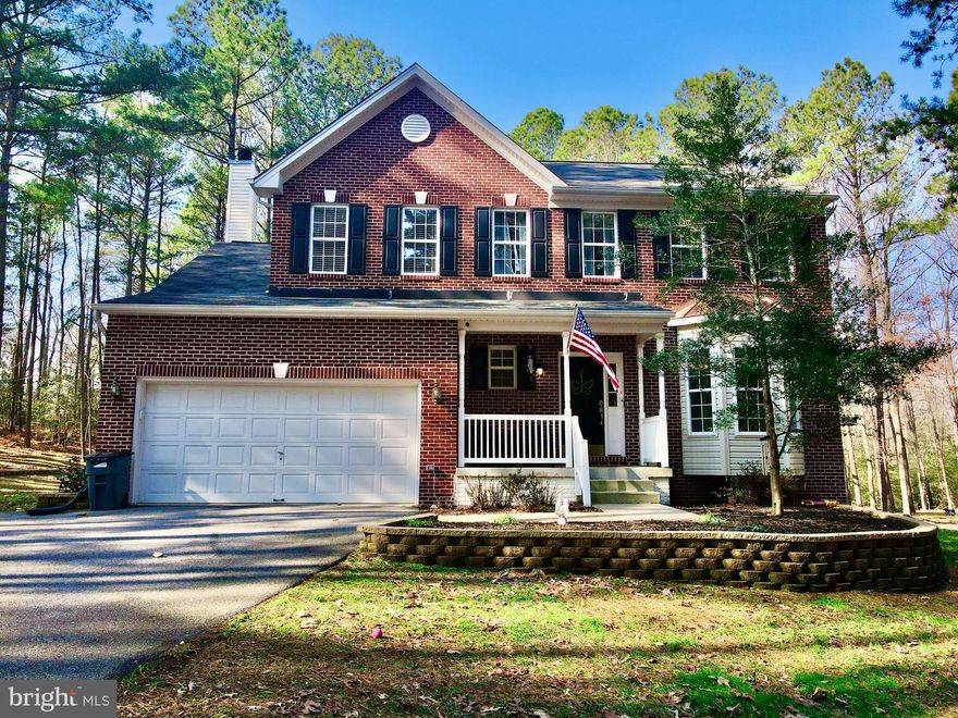 **Check out the video tour on the property** Welcome to an unparalleled retreat where timeless colonial elegance meets modern sophistication on a sprawling two-acre estate. This distinguished home offers four generously appointed bedrooms, 3.5 lavishly designed bathrooms, an attached 2-car garage, and a fully finished lower level with the potential for a fifth bedroom, home theater, or private wellness retreat. The chef’s kitchen is an entertainer’s dream, featuring a grand quartz island, premium stainless steel appliances, and exquisite custom cabinetry, flowing seamlessly into the inviting living area with a statement fireplace. Expansive glass doors lead to a sprawling Trex deck, perfect for al fresco dining and entertaining. The primary suite is a sanctuary with soaring ceilings, a spa-inspired ensuite boasting a soaking tub, glass-enclosed shower, dual vanities, and a generous walk-in closet. The lower level offers a stylish mini bar, additional living space, a full bath, a laundry room, and abundant storage, easily adaptable for a private gym, wine cellar, or guest suite, all complemented by an efficient boiler heating system for year-round comfort. Outside, a spacious storage shed enhances functionality, while the expansive backyard provides a private oasis with endless possibilities for recreation or future enhancements such as a pool or outdoor pavilion. Perfectly positioned with convenient access to top-rated schools, high-end shopping, and gourmet dining, this estate offers the best of both worlds—secluded luxury with effortless accessibility—just 26 miles from NAS Patuxent River, 40 miles from Joint Base Andrews, and 50 miles from Washington, D.C. Experience the grandeur and tranquility of this stunning colonial masterpiece—schedule your private tour today!