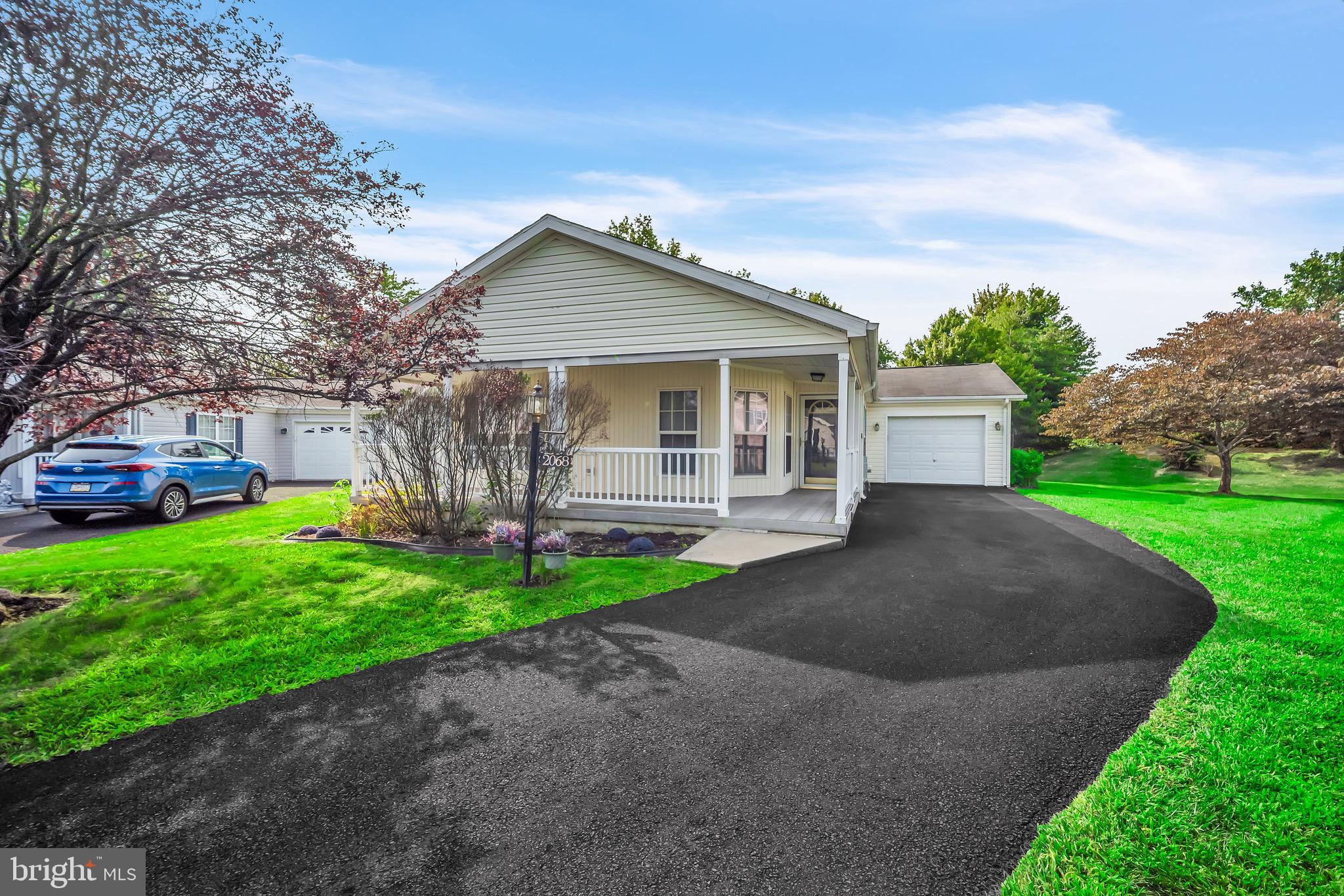 Terrific location in the park, picturesque setting. Open large covered front porch. Large living room with lots of natural light. Terric kitchen with plenty of cabinets and counter space adjacent to the dining room. Large main bedroom with an unbelievable walk-in closet. Spacious main bath. Hall bath with a double shower. Good sized second bedroom Bonus room formerly used as an office but could be a bedroom. Laundry room with exit to a large garage. This is a fabulous over 55 community close to major highways yet tucked away in its own private setting.