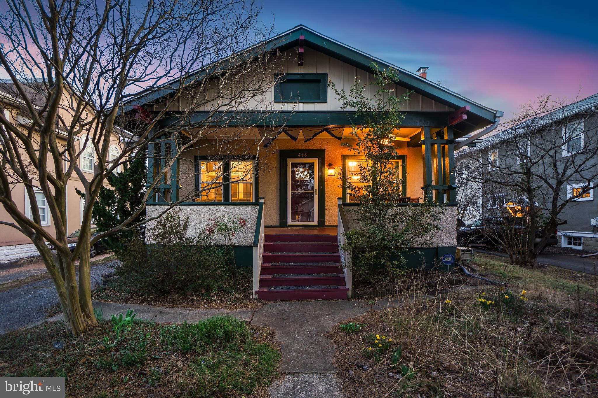 Welcome to 433 Ethan Allen Avenue, a storybook 1925 bungalow blending vintage charm with modern updates in the heart of Takoma Park. This delightful home is brimming with character, featuring a welcoming covered front porch, wood flooring, original architectural details, and a thoughtfully designed lower level.
Step into the bright and airy living room, where a classic fireplace serves as the focal point. The adjoining dining area flows effortlessly into a beautifully remodeled kitchen, complete with striking blue quartz countertops, updated appliances, a skylight, artisan tile backsplash, and stylish pendant lighting. The main level also includes three cheerful bedrooms with wood flooring and ceiling fans, along with an updated full bath.
The lower level offers a fantastic extension of living space, featuring a spacious recreation room with recessed lighting and colorful carpet tile flooring, a cozy family room nook, a second full bathroom, and a large laundry room with abundant storage.
The private, fenced backyard is a gardener’s dream, offering garden beds, plenty of space for outdoor activities, and a peaceful retreat. The inviting front porch is perfect for relaxing, and the private driveway provides off-street parking. The home is also equipped with client owned solar panels, adding an eco-conscious and cost-saving benefit.
Enjoy the unbeatable location just steps from Old Town Takoma and the Coop. With the Red Line Metro station just a mile away, commuting is a breeze, while nearby parks—including Colby Park, Jackson Boyd Neighborhood Park, and Spring Park—offer green spaces for outdoor enjoyment. A perfect mix of charm, convenience, and community awaits!