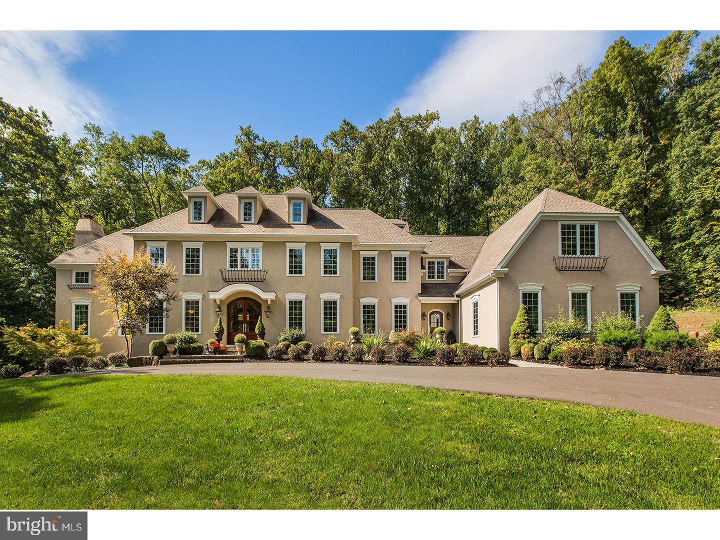 Privately perched on a 13+ac. hillside, a long circular driveway approach leads to this stately 6 BR 4.1 bath home that has been carefully updated inside & out! Beautifully appointed detailing including gleaming new hardwood t/o the 2nd floor hallway, freshly painted rooms,new staircase runners, custom millwork, 9 ft. ceilings, 4 fireplaces, front & rear staircases, over-sized Pella windows & French doors, & more grace this home! All stucco has been inspected & is in "like-new" condition, incl. a new finish coat on the entire fa ade! An inviting double front door leads to the center hallway, flanked by spacious living & dining rooms. A butler's pantry w/wet bar & wine cooler is great for entertaining, positioned near the step-down Great Room w/commanding stone fireplace. The wonderful Kitchen/Breakfast Room showcases antique white & cherry cabinetry, updated designer appliances, incl.a stainless Bosch 5-burner gas cook-top & dishwasher, 2 stainless wall ovens, a warming drawer, Subzero "armoire style"refrigerator, &granite counters w/new custom backsplash! A double pantry closet, desk, center island w/bar stools, stainless farm sink, & granite counters are added amenities! Above the farm sink is a window into the charming solarium w/gas fireplace & tile floors, w/French doors leading to a large paver patio for outdoor entertaining. The Breakfast Room area offers a vaulted ceiling, skylights, & window surround - ideal for everyday meals. Views of the outdoors are everywhere! A private office w/cast stone fireplace & built-in cabinetry is a wonderful respite. A secondary foyer/music area, leads to a large mud room & oversized 4-car attached garage, extra deep for larger vehicles. The 2nd floor is compartmentalized, allowing for privacy. At one end is the main bedroom suite w/2 walk-in closets, a full bath w/large shower & jetted tub, & a separate sitting room/office. Three bedrooms share a large hallway bath, & an upstairs landing near the back staircase is a great lounge/study area. Close by are two addit'l bedrooms, a bath, & oversized laundry. An easy conversion would allow for in-law quarters! The floored, walk-up attic w/dormers is a bonus! The finished lower level is carpeted, & offers a gas FP, b/in wet bar, gathering & game areas, a gym, wine closet, full bath w/shower, & side walk-out. Utilities incl. zoned propane HVAC, central security & central vac, pre-wired music, & holiday lighting. Located in a prime neighborhood with golfing nearby