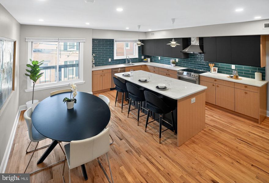 Complete Renovation of this split level Rowhouse, over 2000 sq ft, in the Fairmount neighborhood.  Newly installed solar array projected to offset at least 92% of the household energy use! Enter in to a generous entry tiled Hall, with direct access  to a full sized garage. Down a few steps there is a large coat closet, rear office/den/gym space with half bath, laundry area, mechanical area and polished concrete floors  Half level up to a full width Living Room, with high ceilings, recessed lighting, red oak floors and sliding glass doors to bricked patio.  Another half a level up to Kitchen/ Dining.  Kitchen with custom white oak cabinets, pantry, stainless steel appliances- induction stove top and convection oven, island with built in microwave drawer,  quartz countertops, tile backsplash and wood floors. Up to a rear Bedroom with large closets, Hall tiled Bath with shower and custom white oak vanity.  The front main Bedroom with cathedral 
ceiling,  ensuite bath with double sinks, custom made  white oak vanities and a wall of closets.  Another rear bedroom with cathedral ceiling, wood floors and large closet.  HVAC and Hot Water Heater new  in 7.2025