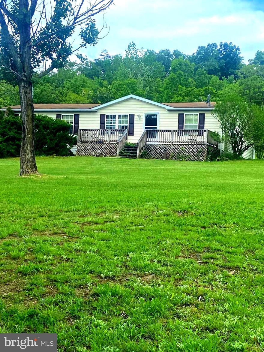 Welcome to wild, wonderful West Virginia!  This  manufactured  home on a permanent foundation is on almost three acres with no HOA!!  This home is open!!  The primary bedroom has its own huge bathroom with his and her closets, a soaking tub and a separate shower!!! Minutes to Route 50 for an easy commute. Winchester is only 30 minutes away.  Restaurants and shopping in Romney is only a few minutes away. This home can easily be a weekend getaway or a full time residence. Did we mention no HOA!   Professional pictures will be uploaded soon.  Don’t miss this one!!