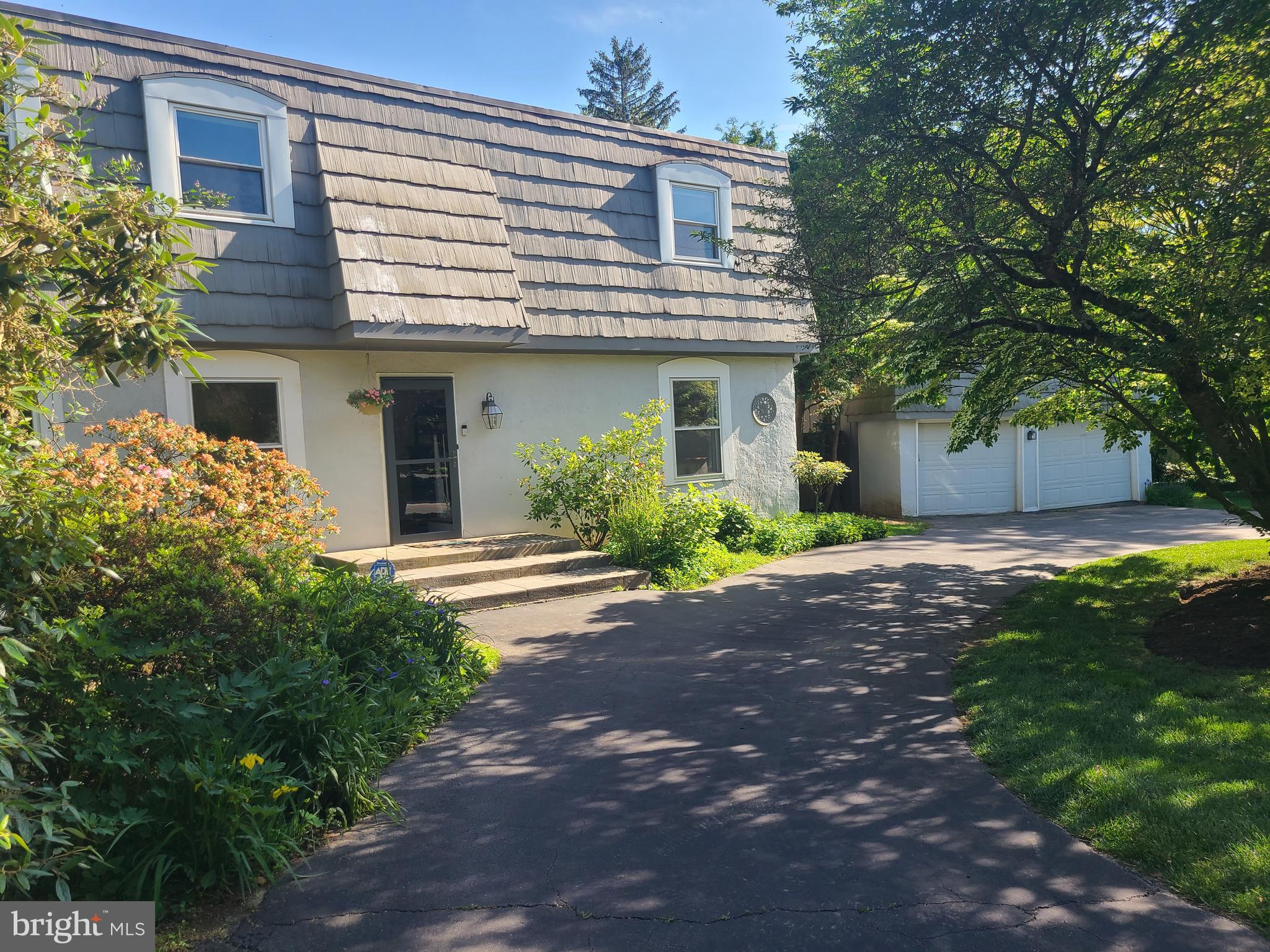 Here is your chance to establish roots in the highly rated suburb of Devon. Charming French inspired cottage coming soon in the Treddyfrin/Easttown School District. Located on a quiet street yet within walking distance to the Devon train station, this 2,000 sq ft, light-filled home has 3 spacious bedrooms and 2.5 baths. When you enter the home through the striking 2-story foyer, you’ll notice that this first level has a great floor plan for entertaining with a sizeable bright living room, a formal dining room, powder room and an eat-in kitchen with exit to outside. On the other side of the kitchen is a spacious family room with antique barn siding floor, a stone fireplace, floor to ceiling bookcases and access to a secluded deck. On the second floor you’ll find a spacious primary bedroom with walk-in closet, a beautifully tiled ensuite bathroom, 2 additional bedrooms and a 2nd full bath. Other features include a first-floor laundry and a large basement with high ceilings for storage, exercise equipment or an extra play area. Outside, enjoy a beautifully landscaped yard with gardens, a private, fenced-in side yard and a 2-car detached garage on a semi-circular driveway for convenient access. Make your appointment today, or come visit this beauty at one of the upcoming open houses.