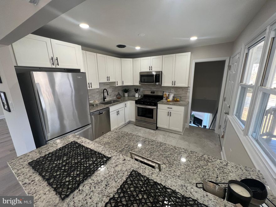 Welcome to a 5 bedrooms and 4 full baths in a cul-de-sac! This single family homes gives you all the amenities, space and luxury your hearts desire.  This single family home has a open floor plan with three bedrooms and two full bathrooms on the first floor. As you enter the spacious living room and dining room the kitchen has beautiful stainless steel appliances with an attached full deck. The lower level has a beautiful entertaining space with a cement walkout and wood fireplace. There is  a bonus on the level level. This additional space has an additional full kitchen with stainless steel appliances.  This area is great for extended guests or older family members. There are also two full bedrooms and two full bathrooms on the lower level. This hidden gem will not last long!  Make this home yours today!