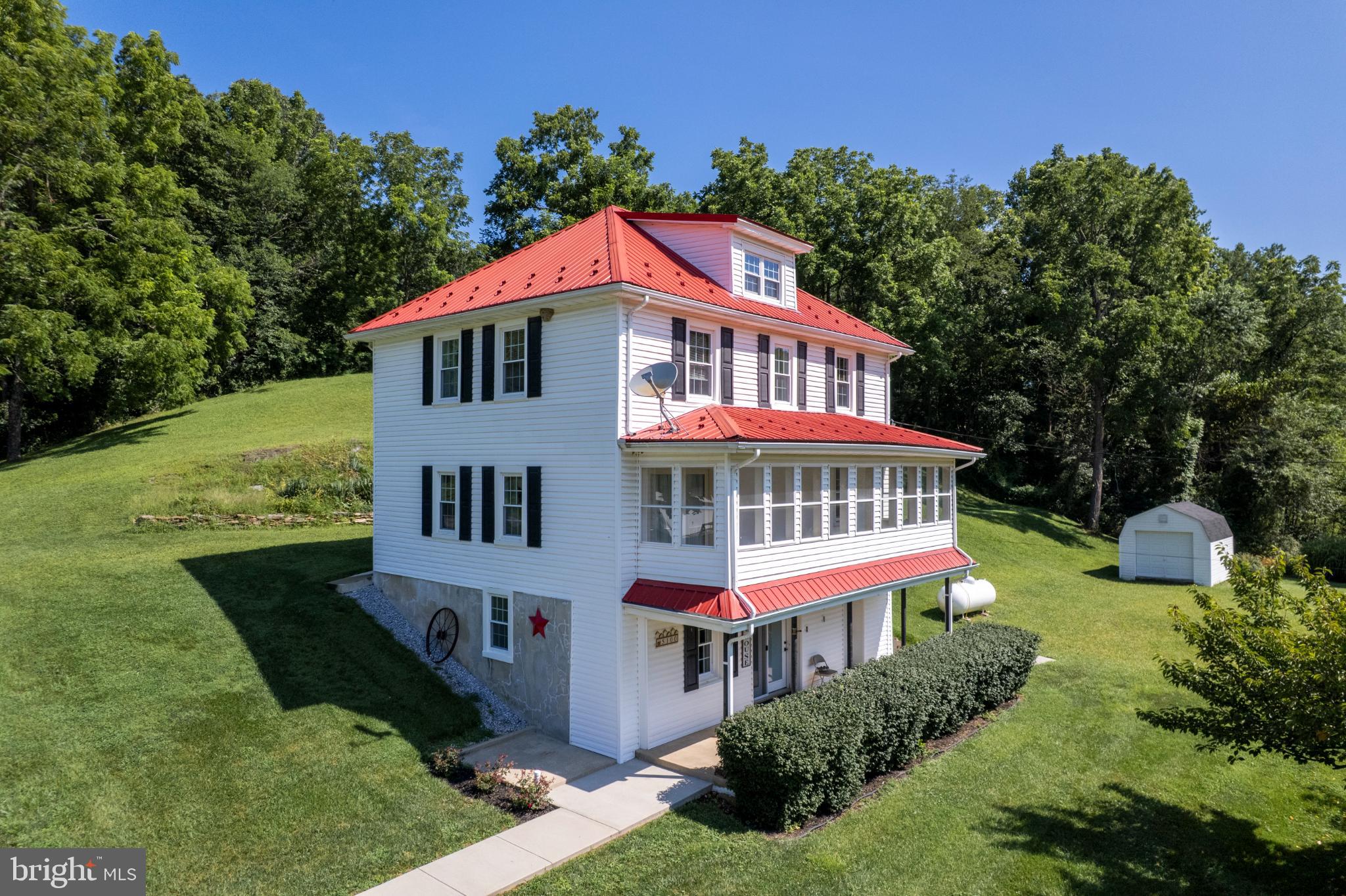 Nestled in a serene setting, this charming Colonial-style residence exudes warmth and character, offering a perfect blend of traditional elegance and modern comfort. Built in 1900, the home has been thoughtfully updated while retaining its timeless appeal, making it an inviting retreat for those seeking a peaceful lifestyle. Step inside to discover a spacious interior adorned with a harmonious mix of hardwood and ceramic tile flooring, creating a welcoming ambiance throughout. The traditional floor plan features a cozy breakfast area, perfect for morning gatherings, and a dedicated dining area that invites memorable meals with loved ones. Recessed lighting and ceiling fans enhance the comfort of each room, while replacement windows allow natural light to flood the space, highlighting the home's inviting atmosphere. The country-style kitchen is equipped with a dishwasher, microwave, and electric oven/range, ensuring culinary adventures are a delight. The thoughtful layout provides ample counter space and storage, making it a joy to prepare meals and entertain guests. This residence boasts three well-appointed bedrooms, providing plenty of space for relaxation and personalization. The bathrooms are designed for convenience, featuring a full bath and a half bath, ensuring comfort for all. Venture outside to appreciate the expansive lot, which is cleared and backs to lush trees and a gentle stream, offering a picturesque backdrop for outdoor activities. The property features multiple outbuildings, including a bank barn, garage, and shed, providing secure storage and endless possibilities for hobbies or projects. Enjoy leisurely afternoons on the enclosed porch, where you can soak in the scenic vistas of the surrounding pasture and woods. Parking is a breeze with a detached garage that accommodates up to ten vehicles, making it ideal for those who value convenience and space. The property is designed for an exclusive lifestyle, where tranquility meets functionality, allowing you to unwind in your own private oasis. This home is more than just a residence; it's a lifestyle choice that embraces comfort, elegance, and the beauty of nature. Experience the perfect blend of charm and modern amenities in this exceptional property, where every detail has been curated for your enjoyment.