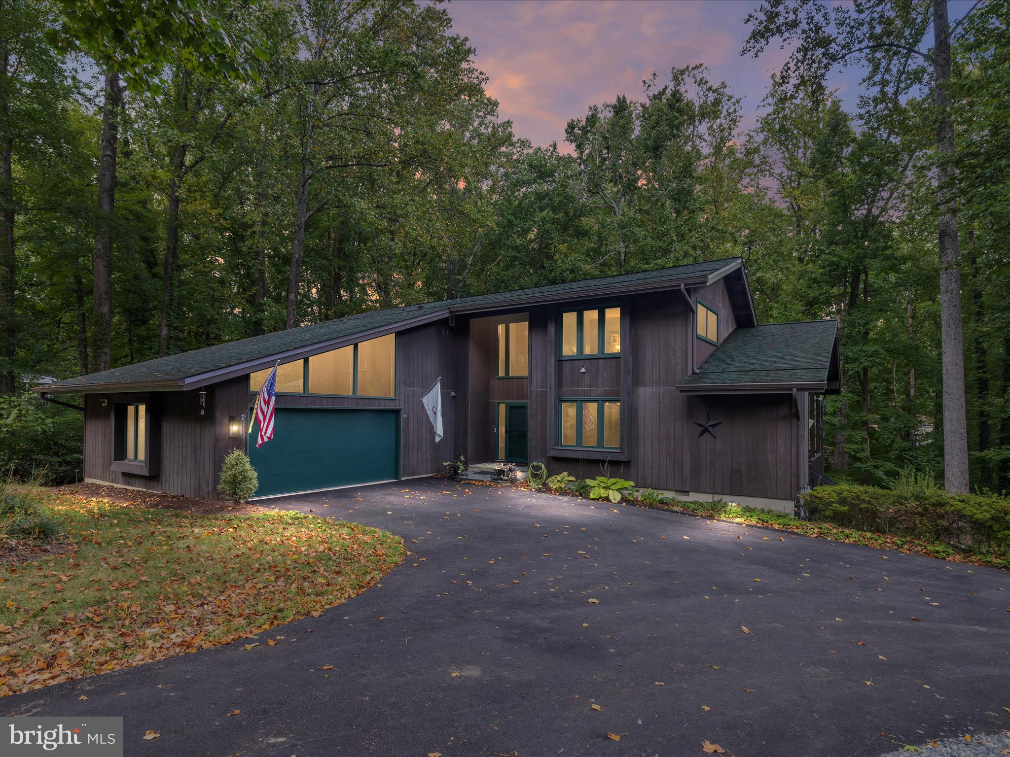Tucked away at the end of a quiet cul-de-sac, this one-of-a-kind Davidsonville retreat is the epitome of privacy and serenity. Surrounded by mature trees, the property welcomes you with a wraparound porch that invites you to take in the peaceful views. The main level features a luxurious primary suite with a recently renovated spa-like bath, custom barn door, and massive sliding glass doors opening directly to the porch. The heart of the home flows with bamboo flooring, Restoration Hardware fixtures, and a chef’s kitchen outfitted with GE Monogram appliances, a gas cooktop fueled by a dedicated propane tank, and custom French doors by Renewal by Andersen. Upstairs, you’ll find two oversized bedrooms and a fully remodeled bath, while the finished lower level offers true versatility—complete with a living room, oversized closet, kitchenette, additional bedroom and bath, and even a fully operational salon. With private exterior access, this level is ideal as a guest suite, home office, or potential rental. Step outside to discover a pond, Almost Heaven sauna, and lush grounds designed for relaxation and retreat. Recent upgrades include a new driveway (2025), roof with 50-year shingles (2020), whole-house Generac generator (2025), Renewal by Andersen windows and doors, remodeled bathrooms (2024), and a high-efficiency Water Furnace 7 geothermal system with dual 200 AMP service
. Added luxuries include a monitored Vivint security system, radon mitigation, and custom touches like reclaimed 1800s wood features from Fells Point. This property is not just a home—it’s a lifestyle. From quiet mornings on the porch to evenings in the sauna, 3305 Blackberry Lane offers the perfect blend of modern upgrades, timeless craftsmanship, and natural beauty.