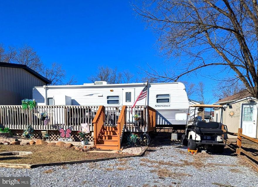 Come and check out this turnkey lot.  Lot comes with a 2012 Keystone Travel Trailer.  Bring your personal belongings and start the 2025 river life. This is a gated community, so you need to enter at the guard shack. Entry is not permitted without ID per the office rules. Bring ID's to the office or guard shack for visitor pass. THIS IS A SEASONAL CAMPGROUND! OPEN FROM APRIL 1 TO NOVEMBER 1. ** WELCOME TO RIVER BEND/SEASONAL LOT AVAILABLE TURNKEY** River Bend is a privately owned 400 acres recreational- vehicle camp resort with seasonal activities for members, families and guests. This great RV park is tucked away on the Upper Potomac River of West Virginia; River Bend is one of West Virginia's most popular family seasonal destinations. Just a short drive from the Washington and Baltimore metro area. Open with utilities from April 1 to November 1. Lot owners have access to their property the entire year. *** Members Enjoy *** * Amazing views and wildlife, Potomac River access, Trails, Swimming pools, Mini-Golf, Youth center, Tennis and basketball courts, laundry facilities, convenience store, deli and lounge. *Bath houses through out the park, boat ramp, bar and grill and even a church located on the grounds. River Bend also hosts numerous activities such as 4th of July fire works, small carnival, bonfires, poker runs, horse shoe tournaments, car show, Halloween Trick or Treat and so much more.