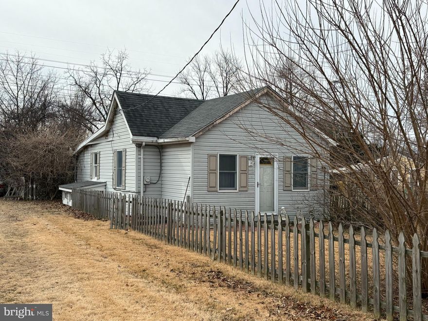 This is the classic "Investor Special" house.  Original owner home that has fallen into disrepair and needs an extensive renovation, or you could tear it down and build new construction.  It has a deep .30 acre lot and the potential of a driveway.  The house needs extensive work and is sold AS IS with all personal property conveying.  There is an enclosed porch that serves as a den, living room, kitchen, laundry, full bath and two bedrooms on the main level.  The basement is difficult to see, but there are two bedrooms (really dens), one has steps to the outside and it appears there is a wood stove in the basement.  The basement is heavily hoarded.  Please exercise caution when viewing and take a flashlight.