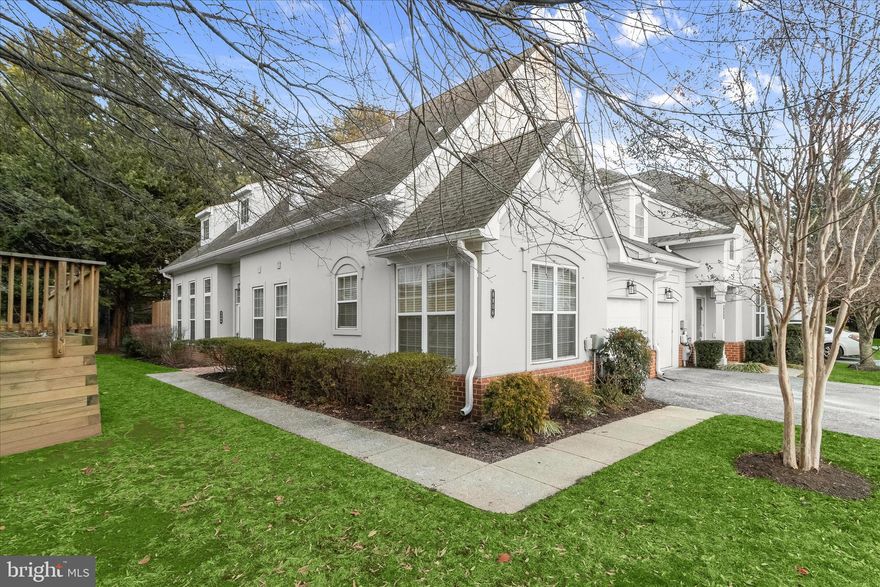 Welcome to this spacious three bedroom, two and a half bathroom condo in the sought-after Grey Rock Villas in Pikesville. Located in a premier gated community, this two-level end-unit home offers a one car garage and a main level primary bedroom suite, filled with natural light complemented by soaring tall ceilings throughout. Step inside to discover rich hardwood floors that continue throughout the open concept main level. The inviting two-story living room boasts oversized windows and has access outside to the back patio, while the dining room is adorned with elegant crown molding. Both the living and dining rooms feature custom motorized window treatments. Prepare your favorite meals in the eat-in kitchen that is fully equipped with stainless steel appliances with gas cooking, granite countertops, soft-close 42-inch cabinets and a pantry. The adjacent breakfast nook provides a spot for casual meals and includes a laundry closet with full size washer and dryer. Located on the main level, the primary bedroom suite is a true retreat with a large walk-in closet and a luxurious ensuite bathroom that has a soaking tub, dual sink vanity and frameless walk-in shower. Finishing the main level is a half bathroom and access to the one car garage. Upstairs, the living space continues with a versatile loft and two additional bedrooms, one of which has a large walk-in closet. The shared full bathroom on this level has a tub shower and a flexible bonus room is perfect for storage, an office, hobby space and more. Grey Rock Villas offers residents access to an outdoor pool and well-maintained common areas, all in a secure, gated setting community. Located in the heart of Pikesville, this home is just minutes from Woodholme Center, grocery stores, restaurants, and major commuter routes including 695, 795, and Reisterstown Road. Some images have been virtually staged.