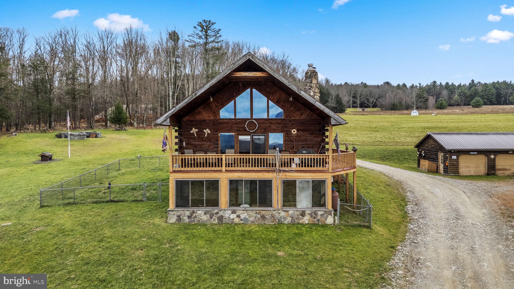 2600+ sq. ft. 3BR/3 BA log home in Susquehanna, PA. Perfect for income generating Airbnb! 2 story great room features stone fireplace and exit to wrap around deck w/ endless views. Main BR with soaking tub and exit to Juliet balcony. Large eat-in kitchen. 75 scenic acres includes 7 ponds, 5 waterfalls , 2 stone quarries and 20'x250' built up worm bed. Detached 4 car garage with new metal roof. 1 Quarry is leased at 15% of gross- minimum income $24,000 annually. Mineral rights available contact listing agent.