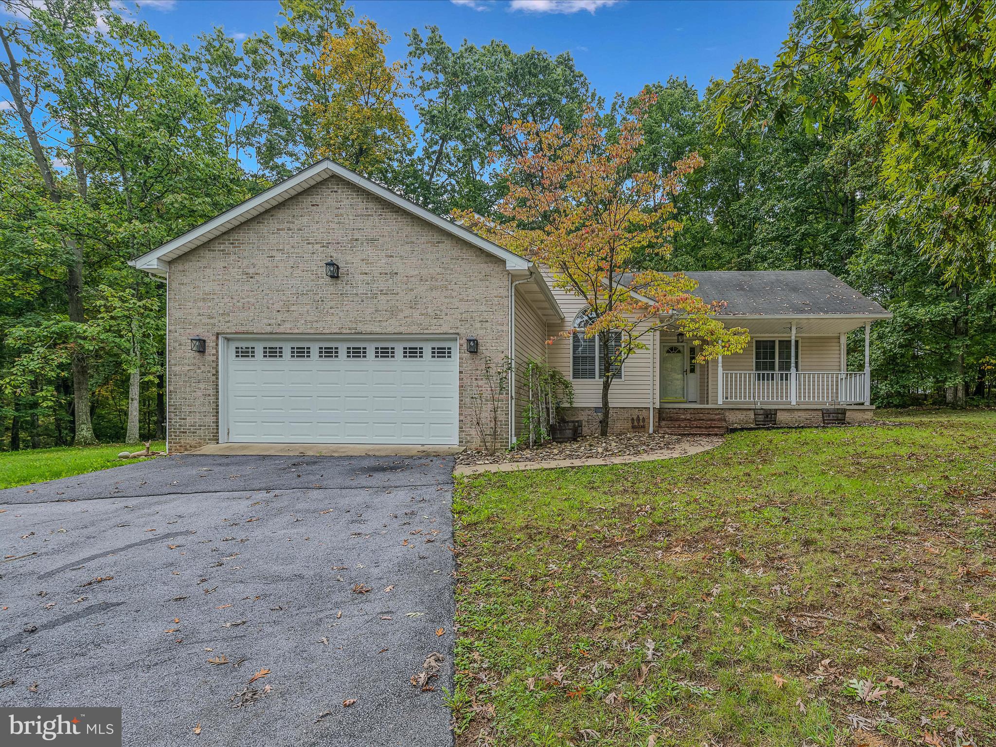 HIGHEST & BEST DUE SUNDAY 9 PM. This lovely 3 bedroom 2 bath rancher has been updated throughout. The house is situated on a beautiful, partially wooded 1.16 acre lot. The large front porch is waiting for some rockers to enjoy the scenic views. Inside you have a welcoming foyer with hardwood floors and overhead light fixture. The hardwoods continue into the open floor plan living and dining spaces. Here you have bright windows and overhead lights. The dining room is conveniently located adjacent to the kitchen. This is a great set up for entertaining. In the kitchen you have hardwood floors, overhead light, and raised panel maple cabinets. The space is topped of with a much sought-after stainless-steel farm sink. Beyond the kitchen you have a spacious family room with hardwood floors, ceiling fan and deck access. The fireplace and accent wall make a beautiful focal point. Then you have a nice mud/laundry room on your way to your 2 car garage with tons of cabinet storage. Down the hall with hardwood floors are your 3 bedrooms. Bedrooms 2 and 3 feature carpet, overhead lighting and ample closet space. Bedroom 2 includes the lovely additional Palladian window detail. The hall bath includes an updated, extended single bow vanity and tub/shower. The primary suite features carpet flooring, large windows and ceiling fan light fixture. You have a private ensuite with separate, extended single bowl vanities. No encroaching or spill over into each other's space - yay! The primary bath also features a 5 ft acrylic tub/shower. Your suite is completed by a huge walk-in closet with awesome built-in shelving. This space has everything you could want in a primary! Outside your large deck steps down to your lush, level backyard. The home backs to mature trees for tons of privacy. This property has everything you've been looking for! Schedule your showing today! **New heat pump to be installed by Seller 1 week before settlement**