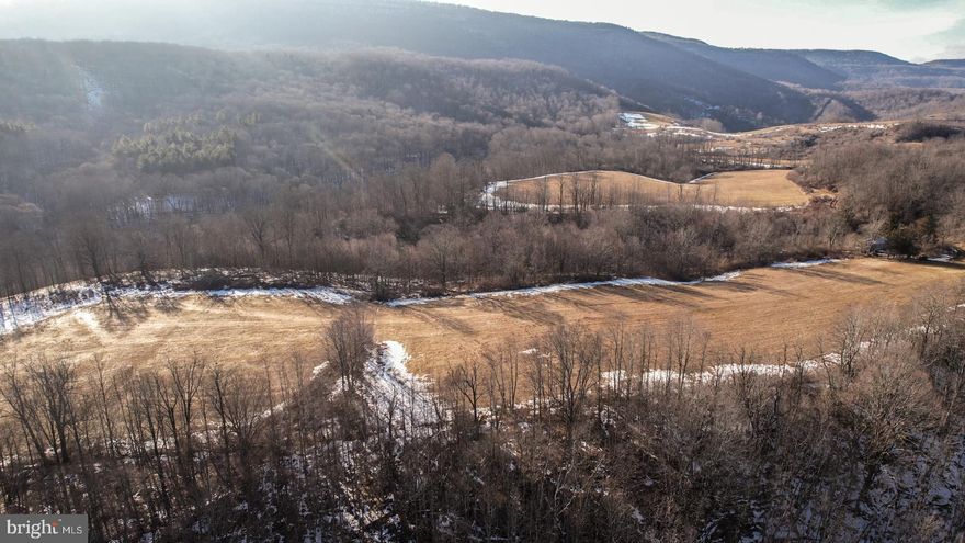Discover the ultimate Appalachian escape on this stunning 248+/- acre property just outside Marlinton, WV. Surrounded by breathtaking mountain views in every direction, this exceptional tract features rolling fields, miles of trails and roads, and frontage along the tranquil waters of Dry Creek. Whether you're seeking a private retreat, recreational haven, or investment in pristine West Virginia land, this property delivers unrivaled potential.

Outdoor enthusiasts will appreciate the property's close proximity to thousands of acres of state and national forest, including the Monongahela National Forest, Cranberry Glades Botanical Area, Handley Wildlife Management Area, and Seneca State Forest. The nearby Greenbrier River Trail and Watoga State Park offer endless opportunities for hiking, biking, and wildlife viewing. In the winter months, world-class skiing and snowboarding await at Snowshoe Mountain Resort, located less than 30 miles away.

With easy access to the charming town of Marlinton, this property blends seclusion with convenience. Whether you're drawn to the land for its natural beauty, recreational opportunities, or peaceful seclusion, this extraordinary slice of West Virginia wilderness offers something for everyone.