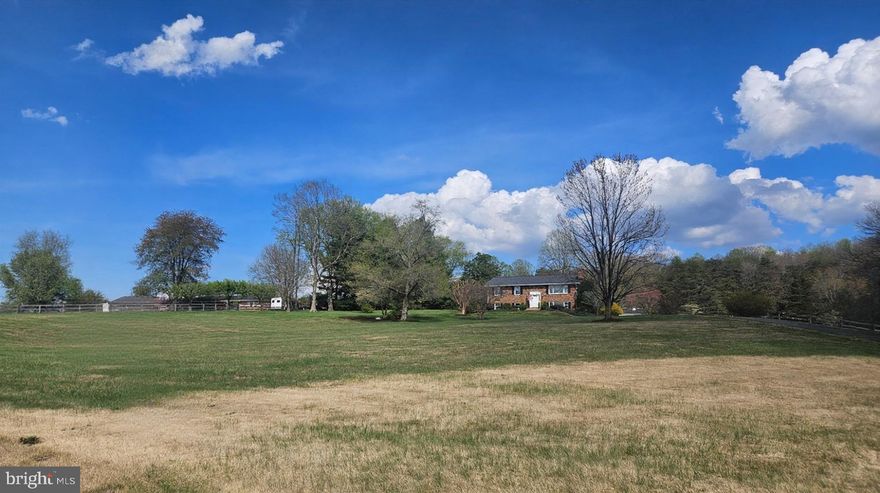 Contact the LISTING AGENT for more information. 
For the first time in over 50 years, one of Georgetown Road’s most coveted addresses is available. Set on a private, elevated 5-acre lot in the rolling foothills of eastern Fauquier County, 6163 Georgetown Road is a 4-bedroom, 3-bathroom home that has been impeccably maintained and lovingly renovated — inside and out — and is now ready for its next fortunate owner.
Wake up to breathtaking sunrise views from the back deck and dining room. Unwind watching the sun melt behind the tree line from the family room’s picture window or the finished lower level. And just across the road, the vineyard rows of Pearmund Cellars — one of Virginia’s most celebrated wineries and home to the oldest Chardonnay vineyard in the Commonwealth — frame your daily view in a way that cannot be replicated at any price. Mature maples, dogwoods, and rhododendrons complete a landscape cultivated with care over more than half a century.
Once a working horse farm, this elevated and fully private lot is positioned to return to that purpose — with the majority of fencing already in place across the rear acreage. The main level was completely renovated in 2025 and the entire upper and main level freshly repainted, giving the home a crisp, move-in-ready feel throughout. Major systems have been addressed: the HVAC was replaced within the last two years, the roof in 2018, and the water heater within the last five years. Replacement windows throughout. The basement was professionally finished in Summer 2025, adding a full bedroom, bathroom, large storage room, and finished storage under the stairs. An outdoor shed with a new ramp provides additional utility. The kitchen retains its original character — solid cabinetry and countertops paired with newer appliances — an ideal canvas for a buyer ready to make it their own.
One standout bonus: this property is one of only two on Georgetown Road with Comcast high-speed internet — a rare and genuine advantage for today’s remote workforce that no fiber map or satellite dish can match.
Minutes from the charm of historic Warrenton, the convenience of Gainesville’s retail corridor, and the wide-open beauty of The Plains. Easy access to I-66 and Route 29.
This is Fauquier County living at its finest. First time on the market in over 50 years. Don’t let it pass.