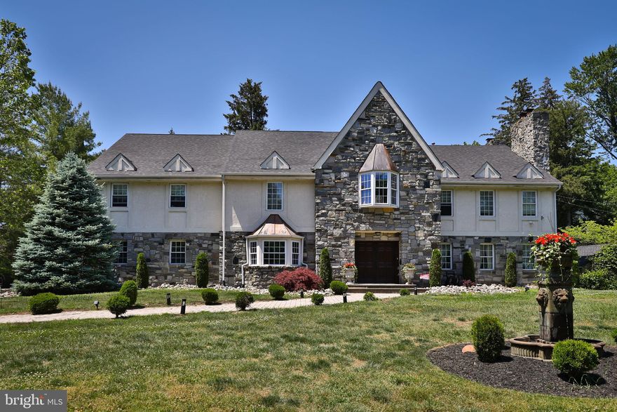 Welcome to fine living in Lower Moreland's Top rated schools. Looking for an in-law suite? Perhaps a home with a brand new roof and updated master retreat? This spectacular center hall, stone Tudor is everything you've always dreamed of and then some. There has been no stone left unturned on this meticulous and thorough renovation. This home is about 10K square feet of pure bliss. Every aspect of has been carefully considered and thoroughly executed at a high level. As you cross the threshold of this fabulous work of art, you step into a 3 story foyer with natural lighting pouring in from all angles. Warm hardwood flooring is as far as the eye can see. Off to the right is a billiards parlor fashioned with a gas fire place. There is a smaller family room next door that opens up to a breakfast room off the gourmet kitchen. Every detail of this kitchen has been carefully considered with a keen eye for detail. The heart of the home is truly this well appointed  kitchen.  Beautiful cabinetry out of Cherry wood, high end, Viking appliances, beveled edge counter tops, plenty of storage, built in desk and seated breakfast bar bring this fabulous space all together.  The dining room with its crown molding can entertain large gatherings. There is a spacious great room with exposed beams that over looks the workout/Yoga and healthcare retreat. With windows all across, the gym has light pouring in from every angle. So many options available at every turn. Next to the workout/gym  is a possible additional  in-law suite, entertaining area, rec-room or maybe even a  basketball court. About 1700 square feet boasting its own heat/AC high ceilings and fireplace. Plenty of natural lighting, the options here are boundless. The master retreat is a total oasis. You will not want to leave this welcoming wing of the home. The master has vaulted ceilings, natural lighting, gas fireplace and spacious sitting/reflection room. Multiple closets and spacious master bath that's been recently renovated. There is even a Jacuzzi, double sink and dressing area. The second floor has a total of 5 bedrooms in all. Third floor has 2 bedrooms, bath and a second laundry area. There is a professional media/movie room with all the stops pulled out.. Incredible viewing with surround sound cap off this incredible space. Next to the movie theatre is a new in-law/au-Pair suite with cooktop, sink, garbage disposal, fridge and separate entrance.  The outdoor living space with pavers abound is both private and cozy.  Plenty of  outside areas to relax in and become one with nature.  There are 4 zones of heat and AC to keep the utility bills in check. 3 car attached  garage to boot. Ideally located within a block to the Rails to Trails entrance, short distance to SEPTA's regional rail, all the major arteries and short distance to all the best restaurants and shops in the valley.