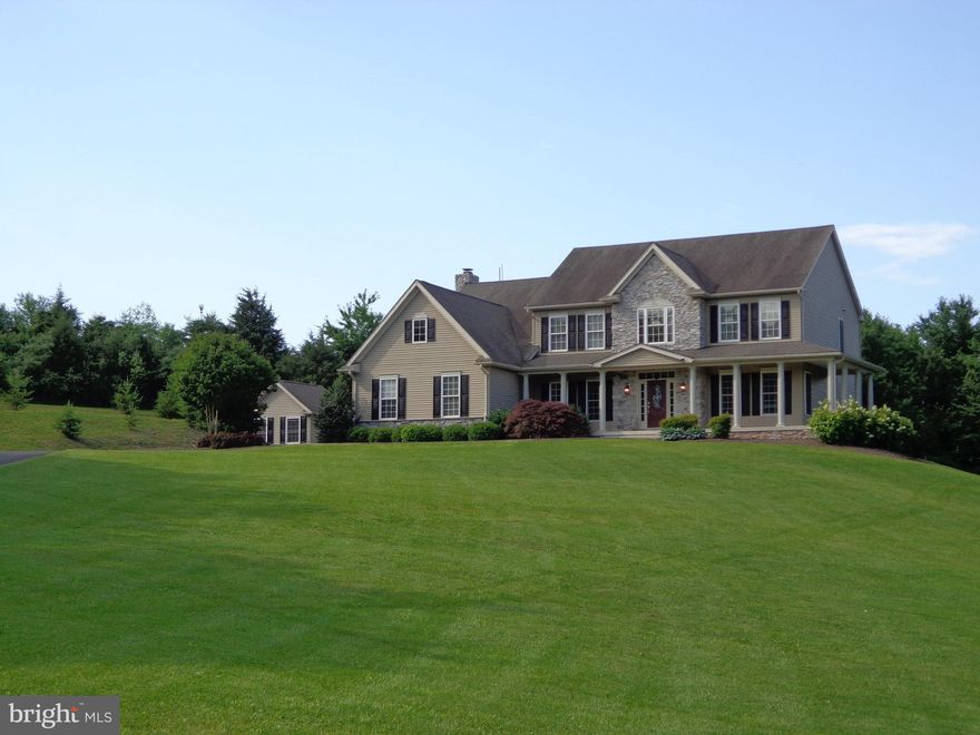 Gorgeous stone front colonial on a private 9.79 acres.Open floor plan with large room sizes. Many upgrades. Hardwood floors on main level and master. Upper level with 3 full baths and laundry room. Sunroom leading to huge 2 level deck overlooking level  park like setting. Separate office/workshop and 3 car garage. Very open finished basement with media/bedroom and full bath Must see to appreciate