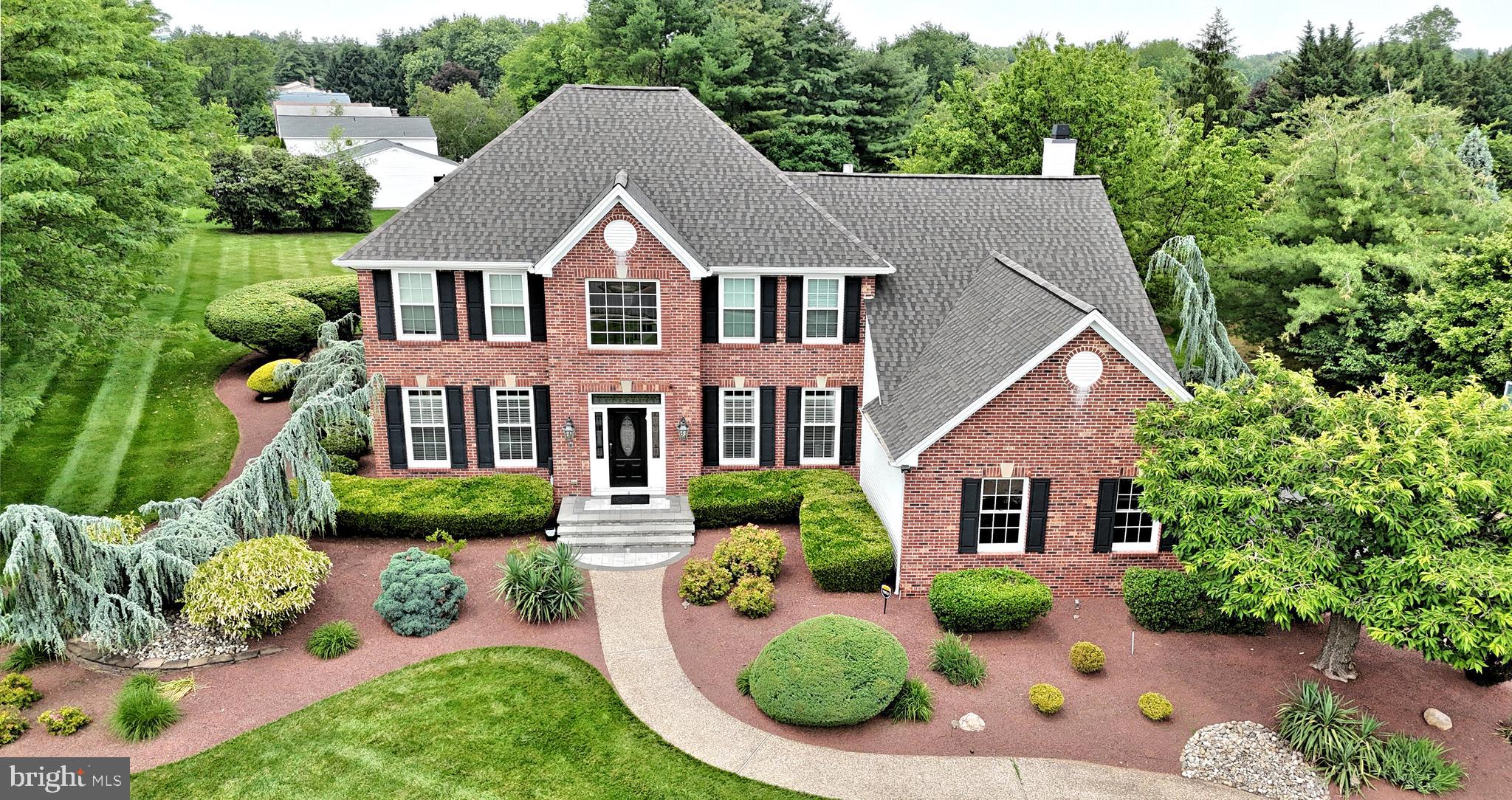 Welcome to this stunning former model home, a true gem in the coveted Northampton Crossing community. Situated on nearly an acre of beautifully landscaped land, this 4-bedroom, 3.5-bath residence is the perfect blend of classic elegance and modern luxury. Throughout the home, you'll find exquisite details, including custom trim work and recessed lighting.
Step through the grand two-story foyer into an inviting open floor plan. The main level features a sophisticated home office with rich hardwood floors and a spacious living and dining area bathed in natural light—perfect for hosting gatherings. The heart of the home is the updated gourmet kitchen, a chef's dream with dark wood cabinetry, granite countertops, a large center island with a wine fridge, a commercial-grade range, and top-of-the-line stainless steel appliances. The kitchen opens seamlessly to the cozy family room, where a vaulted ceiling and skylight create an airy and bright atmosphere.
Upstairs, the expansive master suite is your private retreat. It features a vaulted ceiling, a tranquil seating area, and a spa-like en-suite bathroom. Three additional generously sized bedrooms and an updated hall bath provide plenty of space for family and guests.
The professionally finished basement offers a versatile space for every need, complete with a full bathroom, a wet bar, and a dedicated home gym.
Enjoy outdoor living on the large paver patio, an ideal spot for summer barbecues and alfresco dining. The private, lush backyard provides a tranquil escape with mature trees and professional landscaping. A two-and-a-half-car garage offers ample space for vehicles and storage.
Located in the highly-rated Council Rock School District and just minutes from local amenities, this exceptional home offers the perfect combination of luxury, privacy, and convenience. Don't miss your chance to own this exquisite property.