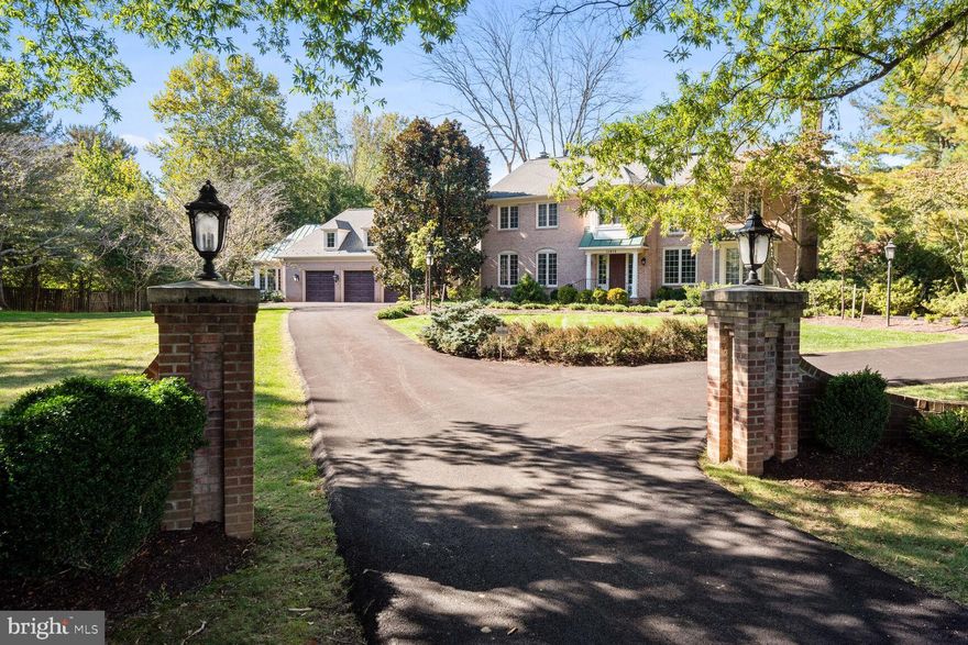Welcome to this sensational expanded/updated colonial with over 5,750 sq ft of living space throughout 3 levels, sited on an idyllic 2-acre lot with a circular drive, a 3-car garage, and a tranquil private backyard designed for entertaining & relaxation with multiple decks & terraces, and a heated inground pool!  The main level of the home has a welcoming foyer entry with a coat closet, powder room, a 5th bedroom w/ensuite full bath (currently configured as an office/library but easily converted into a bedroom), with rich built-in cabinetry & shelving, and built-in bar, the formal living room with a fireplace & bay window, formal dining room with bay window, an updated and open kitchen w/premium cabinetry, granite tops & a breakfast room with a bay window.  The oversized family room showcases a fireplace with a raised hearth, custom built-ins, and a wall of windows & French doors that open to the pergola-covered deck and terraces.  The hallway accesses the large walk-in pantry closet and an exit door to the breezeway/screened-in porch and entrance to the oversized 3-car garage (with a "dog bath" and stairs to a floored attic for extra storage), AND a 10'x17' greenhouse with cabinets, countertop with sink, high ceiling, and separate A/C system.  The upper level encompasses a luxurious primary bedroom suite with 2 walk-in closets, a cozy sitting/dressing room with fireplace & custom built-ins, and an updated spa bath with a dual sink vanity, separate tub, and a large glass enclosed shower.  There are 3 additional generously sized bedrooms (one with an ensuite full bath) and a 3rd full bath.  The lower level walkout has a huge recreation room (pool table conveys) with a fireplace, a built-in bar, a den, a full bath that opens to a sauna, and the laundry room.    Other amenities include hardwood floors throughout most of the main & upper levels, 9' ceiling height on the main level, a whole house backup generator & pool heater (fueled by propane gas),  architectural shingle roof (approx. 10 years), 2 HVAC systems (one system/2019) and an 80-gallon water heater (2015).  You'll feel like you're in the country, but this beautiful property is just minutes from Potomac Village!  Open Saturday (3/23) & Sunday (3/24) from 1-3 pm.