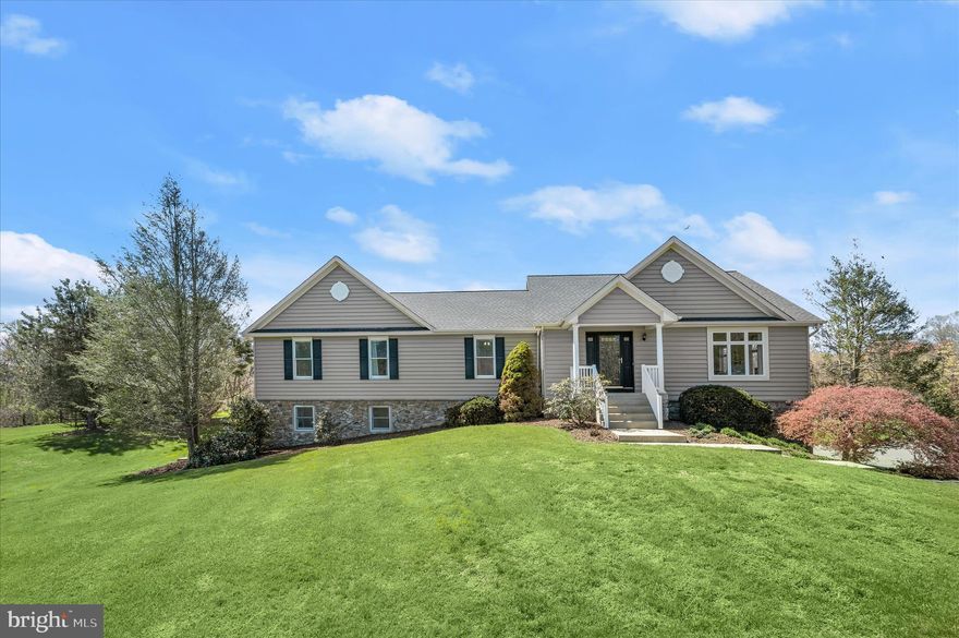 Set on over 4.5 acres of pristine, landscaped grounds, this exceptional rancher offers a rare blend of privacy, tranquility, and convenience, just moments from shopping, dining, and entertainment. A long, secluded approach welcomes you to a property designed for both everyday comfort and unforgettable outdoor living, complete with a sparkling in-ground pool. The picturesque natural surroundings provide both stunning sunrises and sunsets.  Step inside to the main level, where ceramic tile flooring transitions seamlessly into an open-concept layout. The living, dining, and kitchen areas are beautifully appointed with rich hardwood floors, a soaring cathedral ceiling, and an oversized wood-burning fireplace with a brick surround. Floor-to-ceiling windows flood the space with natural light while framing breathtaking views of the property.  The kitchen is thoughtfully designed for both function and style, featuring an expansive center island with breakfast bar seating for 5, granite countertops, stainless steel appliances, 42” cabinetry, a decorative backsplash, and a convenient, extra-large walk-in pantry—perfect for entertaining.  Privately situated at the rear of the home, the primary suite offers a serene retreat with a walk-in closet, updated flooring, crown molding, and chair railing. The en-suite bath includes a double vanity, jetted soaking tub, shiplap accents, and a beautifully tiled walk-in shower. Three additional bedrooms provide flexibility for family, guests, or office space, and are complemented by a well-appointed hall bath with dual vanities and a glass-enclosed tile shower.  The fully finished lower level expands the living space with incredible versatility, offering modern flooring, a kitchenette, a full bath, two potential bedrooms, and multiple gathering areas, including a recreation and game space. Two gas-burning fireplaces, one with a stone surround, add warmth and character, while direct access to the driveway and side patio enhances functionality and provide ample natural light into the area. Buyers will appreciate the many updates throughout and the peace of mind knowing that a new HVAC system was installed in 2026. Ideally located with quick and convenient access to MD-97 and I-70, this remarkable property delivers the perfect balance of peaceful seclusion and commuter accessibility.