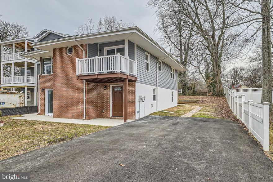 Fully Renovated House with Limited Water View in Desirable Arundel On The Bay. Nestled just steps from the Bay, this fully renovated house offers a modern and open floor plan perfect for contemporary living. 
The main level features a spacious living and dining area with a cozy electric fireplace, creating an inviting atmosphere for both relaxation and entertaining. The brand-new kitchen boasts 42" cabinets, quartz countertops, and stainless steel appliances. A convenient laundry area is also located on the main floor. Upstairs, you'll find three generously sized bedrooms, a cozy sitting area with large windows that allow natural light to fill the space, and a den with sliding doors leading to a front deck. The den could easily be converted into a fourth bedroom if desired. Recent upgrades include all-new windows and doors, new roof, new siding, new HVAC system, new hot water heater, and new well equipment. Enjoy the tranquility of living on a quiet street, just a block from the water, and within walking distance of the public beach at the end of the street, and short drive from Annapolis. This home is the perfect blend of modern updates and prime location, offering everything you need for comfortable living by the water.