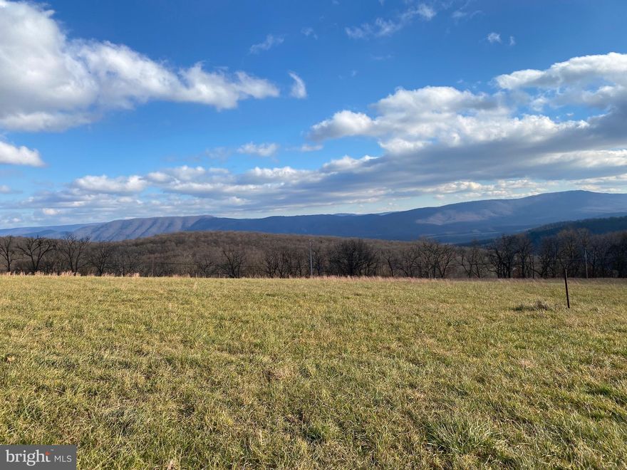 GRAND VIEWS OF MOUNTAINS AND VALLEYS await those lucky enough to live at Orchard View Estates.  Lot 2 just happens to have the best of the best in terms of views, access and utilities.  Paved community road so no dust or gravel and year round access.  PUBLIC WATER and UNDERGROUND ELECTRIC hookup available at the site.  The property is cleared, slightly rolling and ready for your new home.  Established and well maintained neighborhood located just outside and above the bustling town of Petersburg WV.  Petersburg has all the conveniences and charm of a small town and is home to a regional hospital for your medical needs.   Grant County WV is the gateway leading to the outdoor world of the Monongahela National Forest.  Take a drive by this property today just for the views, it will be worth your time.