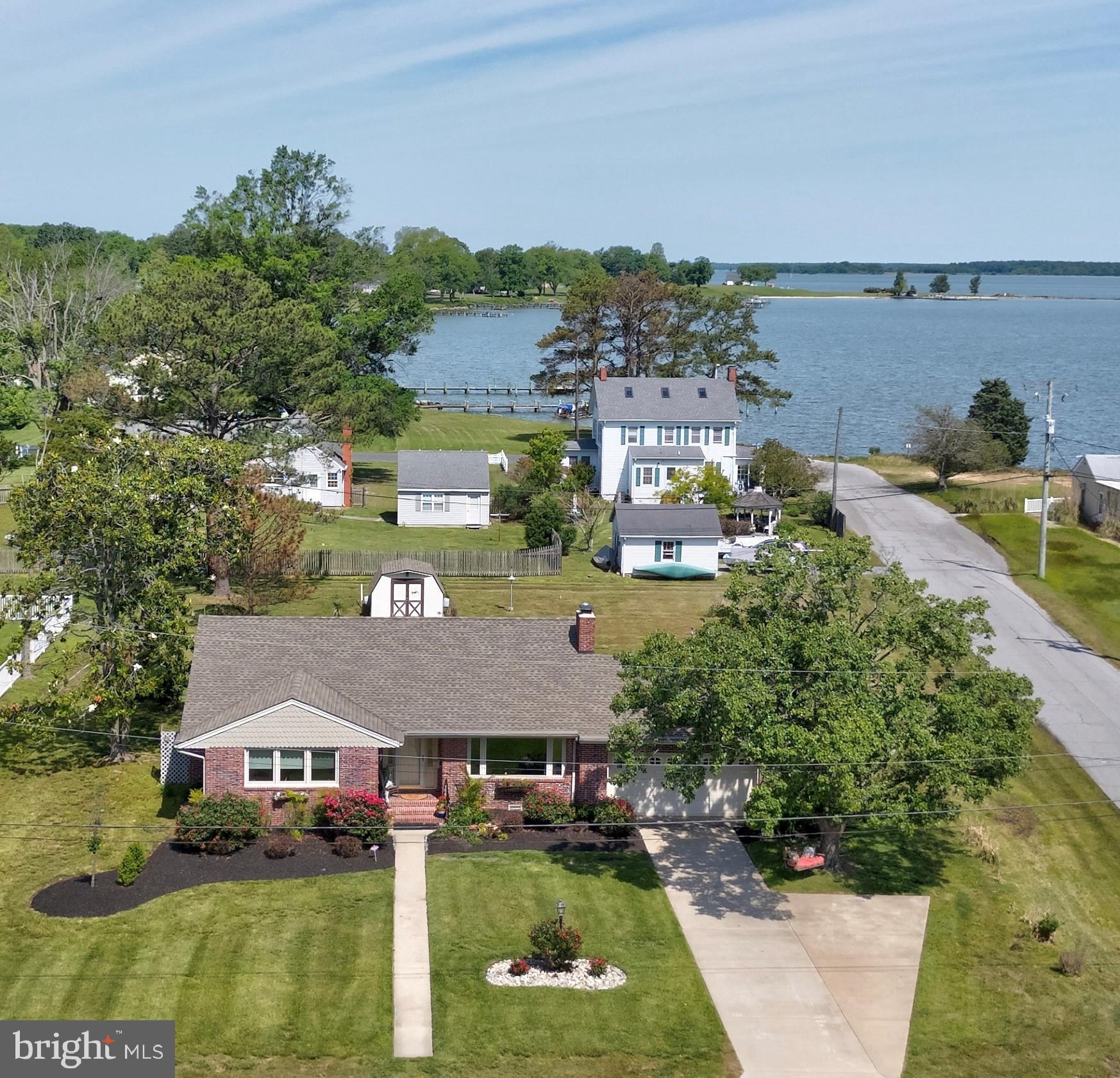 *PRICE IMPROVEMENT* Ready for a new owner to enjoy this treasure... Located in the picturesque Hambrooks Area of Cambridge this cute brick ranchers neighbors are the Gerry Boyle Park and the Choptank River. The waterfront park is literally steps from the front door with open space, piers, and terrific water access. Watch the annual fireworks, boat races, daily boat activity, sunrise and sunsets. 1 Somerset Ave. is in a lovely established neighborhood on a .5 ac corner lot within minutes to the Yacht Club, boat ramp, marinas, YMCA, and very close to restaurants and downtown.
Built in 1960, this 1,578 square foot home offers a comfortable 2 bedrooms, 1 bath, living room with gas fireplace, Dining Room, and Kitchen all with lots of natural light and views. Plus a year round sunroom and two car garage complete the first floor living space. The walk up attic is completely floored with oodles of storage. Anyone will enjoy the established flowering shrubs, plantings, entryway water feature, back patio and waterfall. There is lots of room to add on, plant more or enjoy what you have.
New Roof 2020, Gas Heating system 2024 including central air and hot water baseboard, New carpet 2024 (wood floors under carpet), New Insulation in Garage and attic, New Plumbing in the crawl space.
Cambridge hosts many annual events...Oyster Festival, Eagle Man Triathlon, Iron Man, Powerboat regatta, Skipjack races, Parades , Second Saturday main street events with music, Taste of Cambridge, to name just a few.
This is your opportunity to be a part of a wonderful community and live the Eastern Shore life.