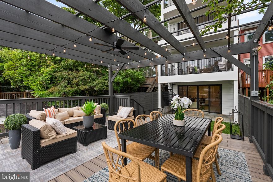 3828 T St NW is a newly constructed, custom-built residence by JM3 Properties that redefines modern city living through elevated design and seamless indoor-outdoor connections. Located in the heart of Burleith, this thoughtfully designed home spans four finished levels with five bedrooms and five and a half baths, offering refined livability and contemporary comfort at every turn. Each floor opens to outdoor space—from the garden-level patio and pergola-covered deck to deep balconies and a stunning full-depth rooftop deck with panoramic and Washington Monument views. An elevator offers effortless access throughout, while wide-plank white oak floors, Andersen windows and sliders, and custom finishes bring warmth and sophistication to every space. The first floor features an open layout with a show-stopping kitchen with a Thermador appliance suite, a nearly 14’ long kitchen island, a dramatic 72" electric fireplace, and expansive sightlines that extend straight out to the rear balcony.

The outdoor connection continues in the primary suite with its own balcony, spa-inspired Porcelanosa bath, walk-in closet, and Grohe rain shower system. Additional en-suite bedrooms, a den, and two laundry areas ensure function matches style. The lower level adds a second living area with a fireplace, wet bar, full laundry room, and direct access to an elegantly outdoor living experience with an 18’ wide custom pergola sheltering a deck and secure two-car carport with EV charging underneath. Perfectly located near Georgetown’s vibrant shops and restaurants, Glover Archbold Park, Georgetown University and Duke Ellington School, and the MedStar Georgetown University Hospital, 3828 T St NW is a fully realized expression of modern living in one of D.C.’s most desirable neighborhoods.  Architectural plans state approximately 3,800 sq. ft. but not guranteed.