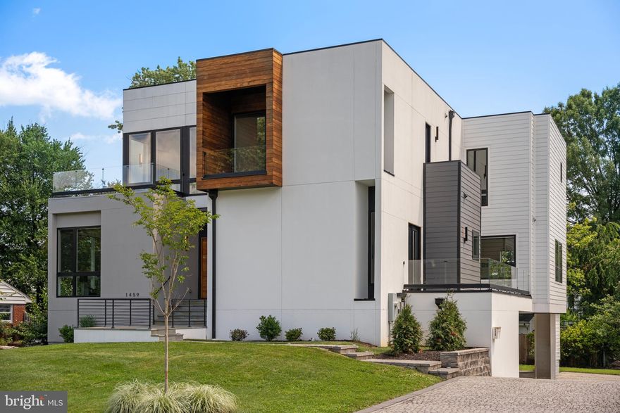 NEW PRICE! A striking modern masterpiece in the heart of McLean, 1459 Dewberry Court seamlessly blends cutting-edge architecture with luxury finishes and thoughtful design. Built in 2022 and offering over 8,100 square feet of refined living space, this contemporary residence showcases a rare combination of sophistication, comfort, and style.

Step inside to soaring ceilings, wide-plank hardwood floors, and dramatic open-riser stairs—all anchored by sleek lines and abundant natural light. The main level features a bedroom suite and a dedicated home office, along with an open-concept living area centered around a state-of-the-art kitchen outfitted with custom Miele and Liebherr appliances.

Upstairs, the luxurious primary suite enjoys beautiful eastern exposures. Two additional bedroom suites complete the upper level. The lower level offers a full exercise room, Bedroom Suite, Recreation area with kitchenette and walk-out access to the secluded backyard—ideal for both entertaining and everyday enjoyment.

Additional highlights include a private elevator to all three floors, multiple balconies throughout the home, and a  3-car garage. Perfectly situated on a quiet cul-de-sac, this home delivers stunning design and modern luxury in one of McLean’s most desirable locations.