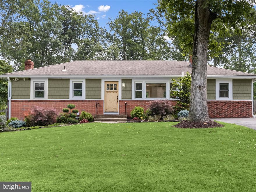 Tucked on a .64-acre lot surrounded by mature evergreens and a graceful willow tree, this beautifully updated rancher blends timeless charm with thoughtful modern upgrades both inside and out. Curb appeal shines with recently updated siding including shake siding, carefully curated landscaping, and a widened driveway redone in 2023, offering a warm welcome and ample parking. Inside, the open-concept main living space is filled with natural light, anchored by a cozy fireplace and picture window in the living room. Rich hardwood floors flow seamlessly into the adjacent dining area and renovated kitchen, where white cabinetry extends to the ceiling and is accented by sleek brass hardware. A spacious island with a breakfast bar, gleaming quartz countertops, stainless steel appliances, and a walk-in pantry complete this stylish and functional culinary space. A powder room near the side entrance enhances convenience, while the main level offers three comfortable bedrooms and a fully renovated hall bath with updated tile flooring, a modern vanity, and a tiled tub/shower surround. The lower level impresses with luxury vinyl plank flooring throughout, a recreation room with an electric fireplace set against a stone accent wall, a fourth bedroom, and a stunning full bath featuring a glass-enclosed walk-in shower. Additional highlights include a mudroom with access to the backyard, a spacious laundry area, and a separate utility room with generous storage. Outdoor living is just as inviting, with a redone deck (2021), a patio for relaxing or entertaining, a sprawling fenced backyard, and a separate enclosed garden area ready for your green thumb. Ideally located, this home offers easy access to nearby shopping, dining, parks, and grocery stores, with Maple Lawn, Columbia, and Savage Mill just minutes away. Nature lovers will enjoy proximity to the Patuxent Research Refuge and Hammond Park, while commuters benefit from quick connections to I-95, MD-32, and Route 29, along with MARC train stations and BWI Airport for added travel convenience.