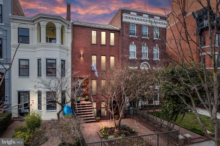 On the market for the first time ever, this multi-family contemporary gem provides for the perfect oasis of quiet and peace in the heart of Dupont. Built in 1977 and designed by architect John Sullivan, this home boasts 3 income-generating apartments in addition to the owner’s 3BR 2.5BA townhome. The main house is an exquisite example of light-filled open concept with soaring ceilings & skylights, and has been newly updated to modern tastes. Refinished original hardwood floors, fantastic exposed brick walls, and fresh paint throughout. The entry level is an entertainer’s dream, complete with flowing living and dining spaces, and culminating with dramatic cathedral ceilings and floor-to-ceiling windows. Refreshed and spacious eat-in kitchen with new counters, custom backsplash and newly painted cabinetry. A lofty 3-level floating staircase leads up to the library, which overlooks the living room and includes large swathes of built-in shelves awaiting your books and treasures. The upper levels also host 3 bright and spacious bedrooms (including 2 potential primary suites), and two ensuite baths upgraded with new counters and custom tile. This home’s ample outdoor spaces are truly special, and include a central courtyard & garden, front brick patio, and expansive rooftop deck. The rear garden is enveloped by high walls covered with Wisteria & Hydrangea. The massive Bradford Pear tree’s shade creates a feeling of protection and softness in the backyard. Meanwhile the rooftop deck is sunny and open while still maintaining privacy, and is an ideal spot for the urban gardener in you. This space could also be converted into a 4th bedroom! Complementing the primary residence are 3 apartments, each 1BR 1BA and approximately 900SF in size. 2 of the 3 units have been substantially renovated within the past 3 years. Top floor apartment of the carriage house features cathedral ceilings and a brick fireplace. For the savvy investor, economic upside possibilities abound with so many spaces! Traditional rentals, tons of AirB&B opportunities, perhaps convert the garages into a 5th unit, or even break the property into condos. The home includes tons of parking (7 total spaces, including a storage area converted from a garage space), 2 additional storage closets off the garage space, and a very functional rear alley with easy access to R and S Streets. Ideally located in the heart of vibrant Dupont Circle. Explore cafes, restaurants and bars on 18th St, U St and 14th St. 1 block to Mint Gym. Enjoy the weekend Farmer’s market on Columbia Rd and Dupont Circle. Transit oriented location with Metro buses on 18th Street and Metro stations nearby (0.7mile to Dupont and U St/Cardozo).