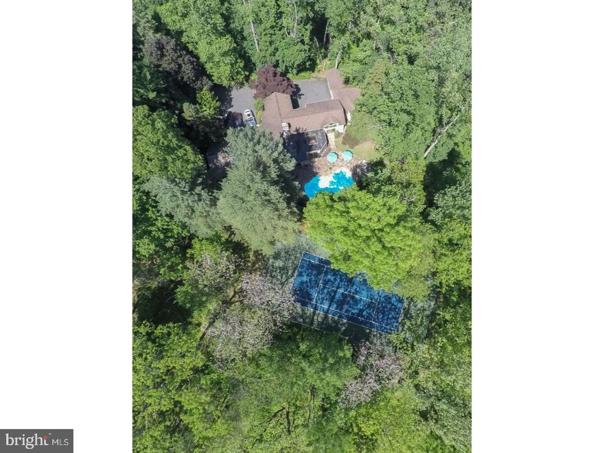 An exciting contemporary home on a lovingly landscaped 2 ac lot sited next to 28 acres of open space and woods. As you enter the home,you are WOWed by the vaulted  soaring ceilings and wonderful open space with over sized windows which allow natural light to flood all the living areas:    Enjoy music or a good book in the Library area    Gather with friends in the Living Room by the stone fireplace and fully equipped bar    Relax in the Great Room    Share a Holiday meal with family and friends in the spacious rounded skylit Dining Room Entertain easily within this open floor plan serenaded by a sound system inside and out  The modern eat in Cook's Kitchen features granite counters, commercial appliances, large walk-in pantry and a large skylight. Walk out onto a stone patio surrounding a beautiful pool with waterfall. Find a comfortable chair to sip your morning coffee as you plan the pool party for that afternoon. A tennis court completes this picture. The Laundry room is next to the kitchen. Beyond that is a private study/5th Bedroom with a full bathroom. This area may also easily be incorporated into the Master Suite.  The Master Suite features a marble bathroom with a steam shower, Jacuzzi bath, double sinks, and 2 toilets + bidet In the joint dressing area are double walk in closets and custom cabinetry, crafted in Lancaster County. Within the actual bedroom, one may enjoy a view of the adjacent greenhouse.  A lovely Powder room is located in the Front Hall. Upstairs are 3 generous bedrooms, each with their own full bath. The lowest level, which is ongrade is unfinished. It provides access to an attached 2 car garage. A Detached 6 car garage is steps away from the house. This truly unique home provides 4 Seasons of spectacular views and is a playground for all ages and all sensibilities. DON'T MISS IT !!!