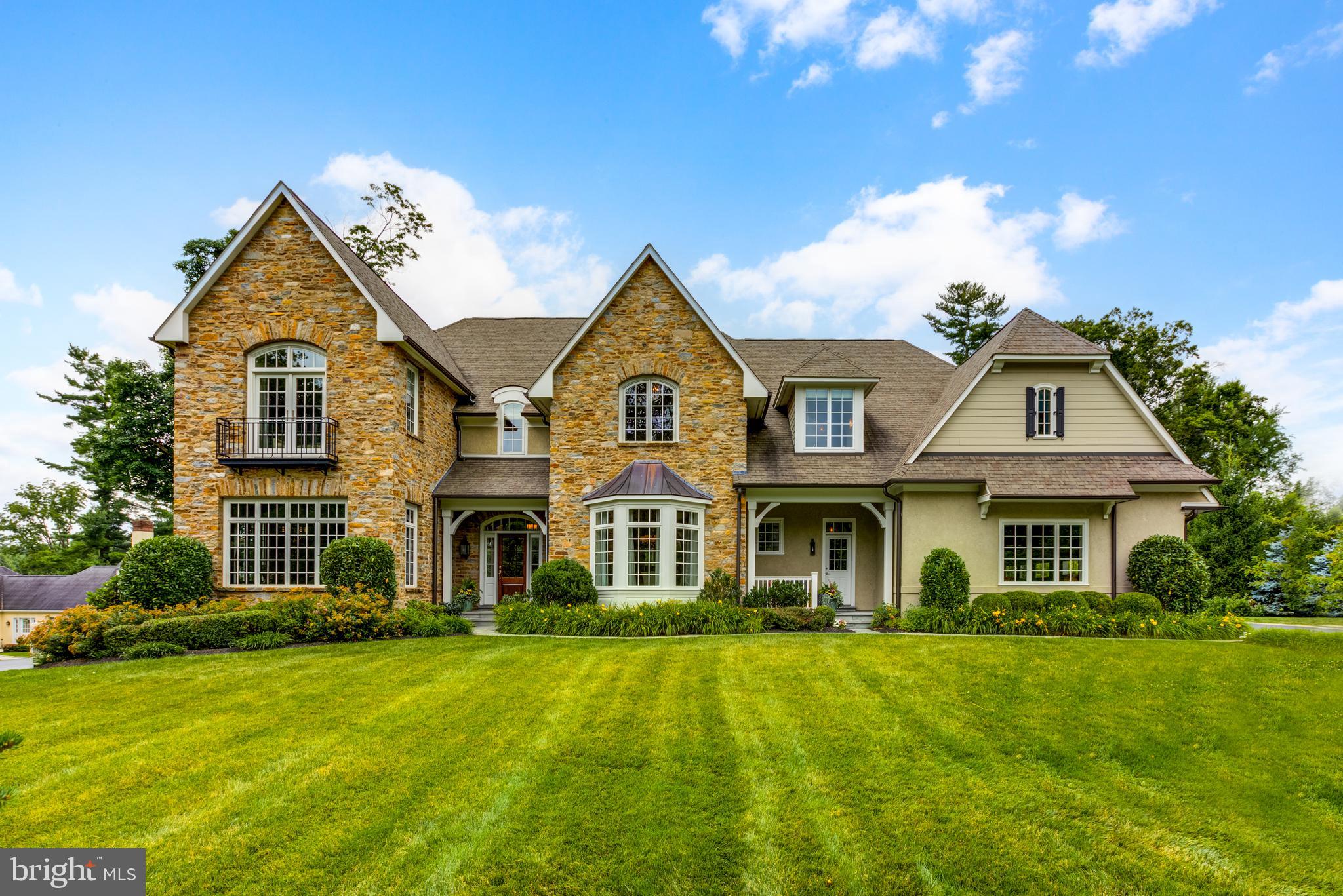 WELCOME TO ASHWOOD HALL. !! An elegant yet comfortable home built by one of Chester County"s most respected builders, Tom Bentley. It features all the modern conveniences today"s sophisticated buyer expects, yet maintains the charm and beauty of the old world. The first floor features a large, 2 story, welcoming center foyer overlooking a beautiful curved, front stairway. It has an open floor plan with 2 offices ; 2 powder rooms ; a large formal dining with beautiful old world moldings and a bay window; an inviting living room with built in book cases plus a gas fire place. The gourmet kitchen features a very large marble island which accommodates 5 - 6 chairs, plus marble counter tops, 42' cabinets , along with a wet bar area, double oven, 5 burner gas stove and it opens to the comfortable breakfast room with an outside entrance; and a wonderful size family room with mounted TV, gas fireplace, beamed ceiling and lots of natural light from all the surrounding windows and glass doors. There is also a "family" front door which leads into the back hall, the 2nd powder room, a back stairway, a coat closet , an entrance to the 4 car garage and a nice walk in pantry, The hardwood floors throughout the first floor add to the warmth of this beautiful home. The second floor features 5 bedrooms, 4 bathrooms plus a laundry room with washer, dryer and laundry sink. Enter the master bedroom through double doors via a cozy sitting room with a gas fireplace. The master bedroom has a vaulted ceiling, 2 large walk in closets, and a luxurious bathroom with his and her vanities , a stand alone tub, water closet, and a large " double" shower with 2 entrances! Three of the other bedrooms have their own baths, while two share a jack and jill bathroom. The lower level has an additional family room, a wine cellar, a game room , an exercise room, a full bath room, plus a large storage room. A window egress completes the lower level! As charming as the inside is, the outside parallels it!!! The professional landscaping and flower beds are in the front of the house, while the lovely flat back yard is open yet surrounded by trees and bushes for privacy. The outdoor sprinkler system helps maintain the yard. Enjoy a swim in the heated pool, or relax on the surrounding patio, or laze about on the covered back patio while enjoying the gas fireplace and watching the mounted TV! All the outdoor teak furniture will stay, for your enjoyment. ( 4 lounge chairs do not convey). This home is truely a masterpiece of enjoyment. It shows like a model, having been maintained beautifully by the original owners over the past 7 years. Move in and enjoy.