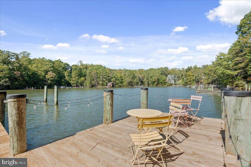 TURN-KEY WATERFRONT RETREAT ON MILL CREEK! This move-in ready Drum Point gem is sold fully furnished, offering a seamless transition to coastal living. Boaters will prize the private pier with 6ft+ MLW, capable of hosting deep-keel sailboats, plus multiple slips and a floating kayak/SUP platform. Situated at a high elevation, this property sits outside the flood plain and features natural storm protection from mature hardwoods. The low-maintenance exterior includes a synthetic slate roof and vinyl siding. The smart multi-level design features a main-level bedroom and full bath, ideal for guests or aging in place. The upper-level primary suite is a private sanctuary with panoramic creek views and a large sitting area. For entertaining, the lower level boasts a custom Tiki Bar leading directly to the water. Proven income potential with 18 months of documented short-term rental history. Ample parking and a strategic roll-up garage door for water gear storage. Don’t miss this rare blend of deep water, durability, and style!