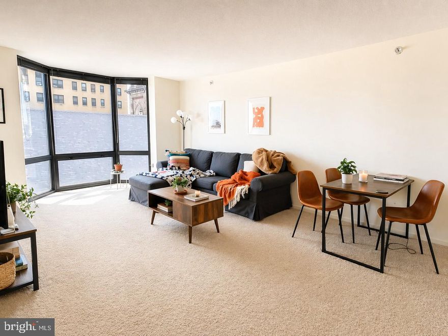 One bedroom with bay windows showcasing southwest sunset city views at Wanamaker House, just one block from Rittenhouse Square! Upon entrance of the home, there is a foyer with a double coat closet. The sun-soaked living and dining room is filled with natural light from large floor-to-ceiling windows. Open to the living/dining area is a kitchen with excellent cabinet and counterspace and white kitchen appliances. The bedroom features a wall closet, another large bay window, and enjoys use of an updated full hall bathroom featuring a single wood vanity with granite top and tub shower. Adjacent to the bedroom, there is a large walk-in closet. Residents enjoy a 24-hour doorman, a seasonal rooftop pool, a fitness center, and a parking garage available for an additional fee (subject to availability). All common areas were recently renovated including the lobby, hallways, meeting room, amenity lounge, and fitness center, designed by world- renowned architect Cecil Baker.