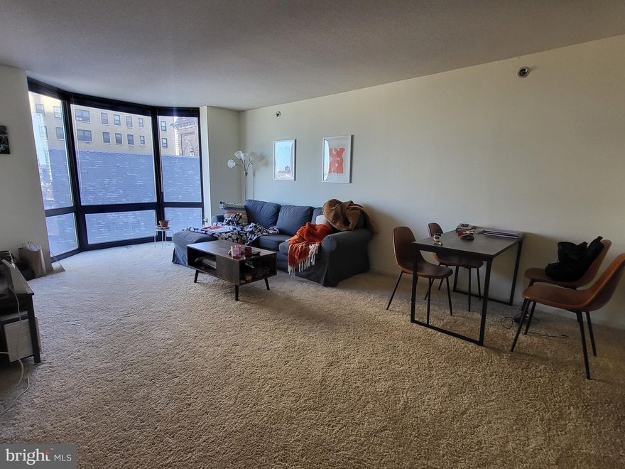 One bedroom with bay windows showcasing southwest sunset city views at Wanamaker House, just one block from Rittenhouse Square! Upon entrance of the home, there is a foyer with a double coat closet. The sun-soaked living and dining room is filled with natural light from large floor-to-ceiling windows. Open to the living/dining area is a kitchen with excellent cabinet and counterspace and white kitchen appliances. The bedroom features a wall closet, another large bay window, and enjoys use of an updated full hall bathroom featuring a single wood vanity with granite top and tub shower. Adjacent to the bedroom, there is a large walk-in closet. Residents enjoy a 24-hour doorman, a seasonal rooftop pool, a fitness center, and a parking garage available for an additional fee (subject to availability). All common areas were recently renovated including the lobby, hallways, meeting room, amenity lounge, and fitness center, designed by world- renowned architect Cecil Baker.