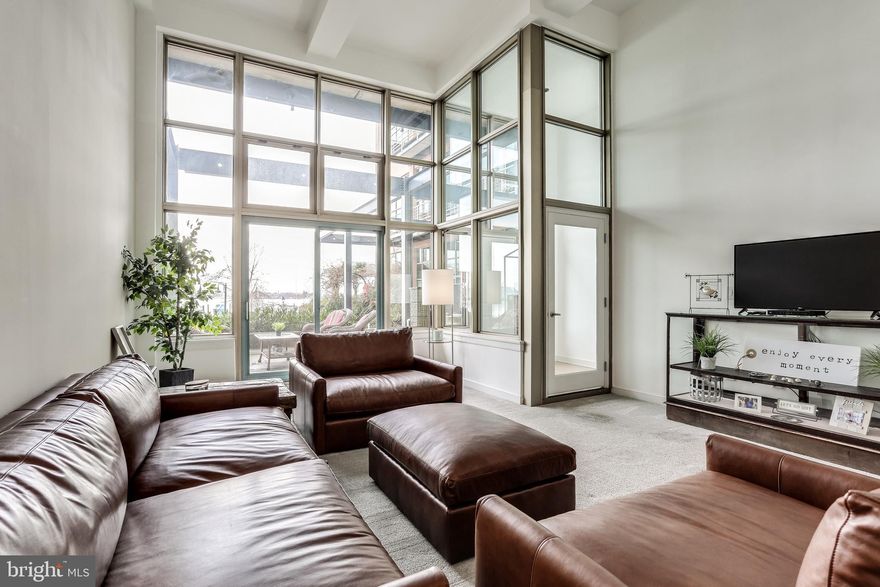 This 3 Bedroom, 2.5 Bath First Floor Condo with Water View in Canton Cove Is A Must See! Enter This Beautiful Two-Story Home From The Front Patio Within A Gated Area. Step Inside to Foyer that Leads to the Bright Living Room with Cathedral Ceiling and A Wall of Floor-To-Ceiling Windows, Offering A Spectacular View of the Canton Waterfront. Continue to the Dining Area with Breakfast Bar Leading to The Kitchen with Stainless Steel Appliances, Gas Cook-top, Wall Oven and Built-In Microwave. The Main Level Master Bedroom Features Carpeting, Pretty Views of the Outdoor Area plus An Attached Master Bath with A Soaking Tub and Separate Shower. A Powder Room/Half Bath Rounds Out the Main Level. Continue Upstairs to Find A Spacious Bedroom Overlooking the Main Level and With Scenic Views of the Waterfront, Plus An Additional Bedroom,  Renovated Hall Bath and Laundry Room. The Lower Level Leads to Your Very Own Covered Parking Space, Right Outside Your Back Door! Additional Parking Spaces Potentially Available For Rent or Purchase. Canton Cove Is Ideally Situated on Canton Waterfront and is Near Shops, Restaurants and All That City Living Has to Offer. Canton Cove Condo Fee Includes 24/7 Security, A Personal Locked Storage Unit, Mail Service, Gas, Water, Sewer & Cable Fees. Canton Cove Meeting Rooms and Rooftop are Available to Rent. Rent A Boat Slip and Walk Only A Short Distance to Enjoy Your Day on The Water! This Home is A Must See!