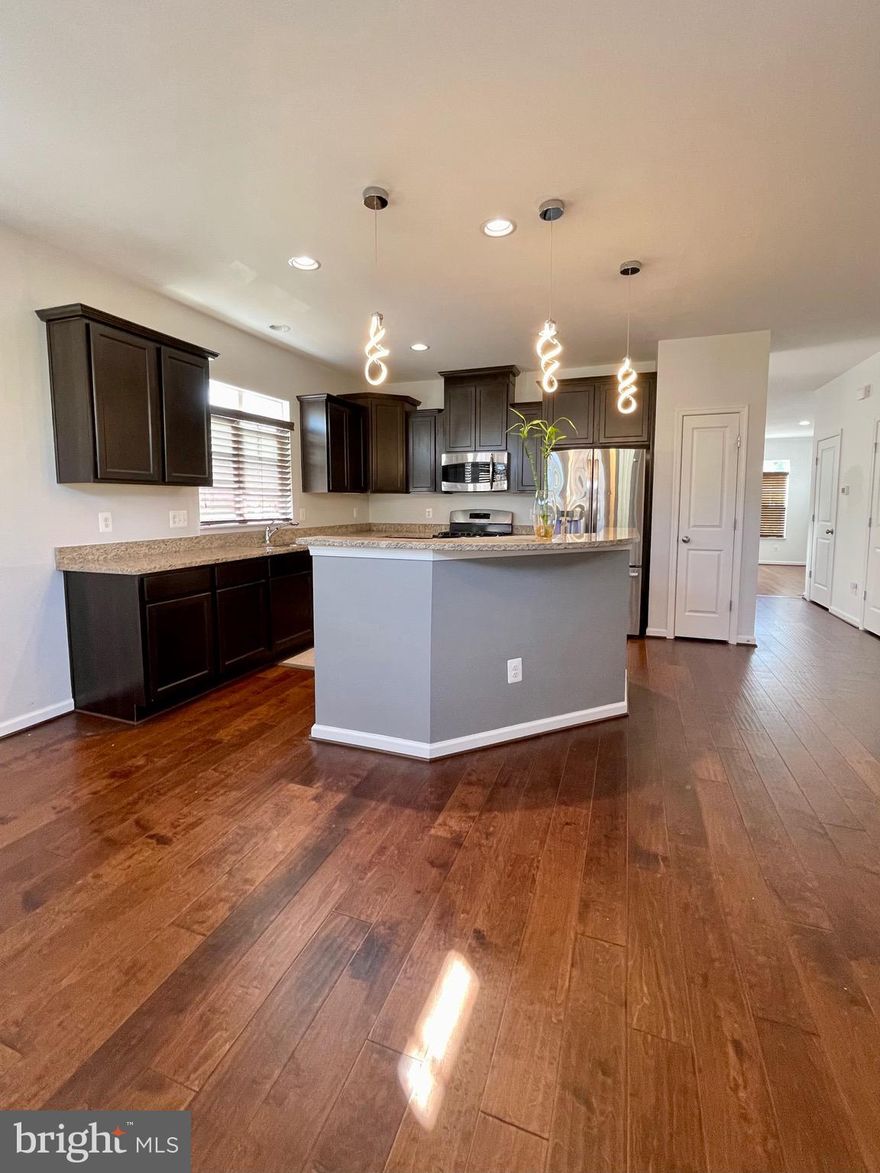 Beautiful 3 Bed/3.5 Baths end unit townhome located in Stafford! Main level with gleaming hardwood floors and recessed lighting throughout. Spacious family room with access to covered balcony. Walk into gourmet kitchen with open layout. Espresso cabinets, granite countertops and island, stainless steel appliances, and beautiful pendant lighting! Room for dining table and bar stool seating. Kitchen leads out to large back deck with views of fully fenced in backyard and trees! Upstairs with carpet and three bedrooms. Primary bedroom having walk-in closet great lighting! Ensuite bathroom includes dual vanity, soaking tub, and stall shower. Two other bedrooms sharing hall bathroom with tub-shower. Laundry located on upper level. Fabulous basement with wood flooring, high ceilings, gas fireplace, and full bathroom! Windows nearly wrap around this basement giving so much lighting. Walkout level to backyard.  2 car garage and street parking available. Convenient to I-95, Rt-1, and Quantico base. Right around the corner of Stafford Market Place with grocery stores, coffee shops, restaurants, and entertainment. Apply on our website.