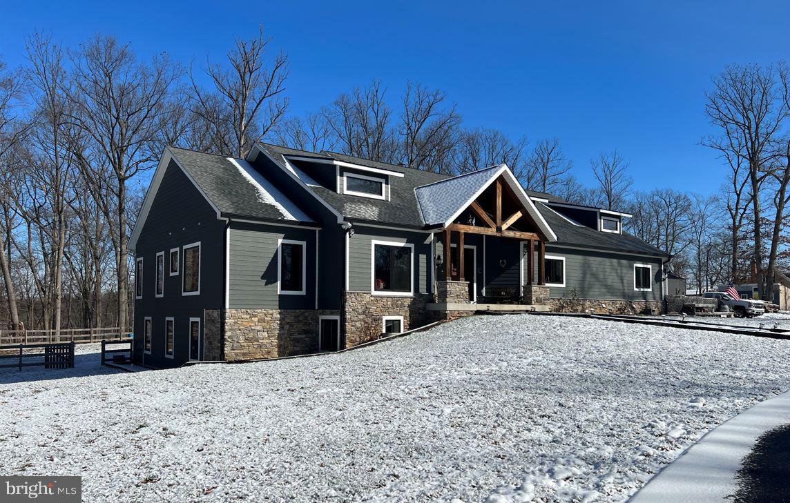 Looking for a VACATION RETREAT for your next home…look no further. This award-winning custom
home sits on 13.52 acres in the heart of Southern Frederick County perfectly tucked away down a long
and winding driveway into an oasis at the top of a hill surrounded by 100s of acres of forest.
As you step into the home, you will be greeted with a generous open concept and a comfortable feeling
of sophistication. Central to the home is an expansive chef’s kitchen with high-end Thermador
appliances, a coffee and wine bar, and a center island (6’ x 9’) that could seat an army. Within the
kitchen is a walk-in pantry and adjacent is a large mudroom, one-half bath, and separate laundry room.
The great room, consisting of the main family room, a sitting area with a wood burning fireplace, and an
informal dining room, boasts 14’ ceilings and exterior views of your beautiful property. The home has 4
bedrooms, two on the main level and two on the lower level, each with its own en-suite bath and walk-
in closet. The main floor primary suite is fabulous! It includes a built-in desk area, a sitting space with
gas fireplace for a cozy space to read, an enormous en-suite bathroom with a glass shower, a soaking
tub with spectacular views, and a large walk-in closet. The guest bedroom suite on the main level is
perfect for an elderly family member or the little ones.
Still need more space? The lower level is an entertainer’s dream with the swag of a media room, large
bar, and the same open concept as above to host massive get-togethers. There is also a gas rough-in if
you want to add a fireplace. In addition to the large, bright 3 rd and 4 th bedroom suites with massive
bathrooms, there is also an even bigger craft room/office that can easily be used as a 5 th bedroom.
As you have probably noticed by now, the windows are oversized single pane picture frames giving you
unobstructed views of the nature around you. Those views will entice you to step out on to an
expansive back porch, the perfect spot for a cup of coffee in the morning or a relaxing dip in the hot tub
in the evening. The outdoor area also features a large patio (with rough-ins for electric and propane for
your exterior kitchen), a deck by the hot tub, an outdoor shower, and a fire pit. Last, but not least, take
advantage of a 30’ x 48’ metal barn with electric and water for all your toys and/or workshop and the
10’ x 24’ SHE shed with electric because the ladies need their space as well.