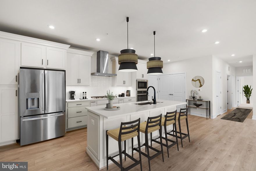 Don’t miss your chance to own a home in an incredible community! This brand new MAIN LEVEL ACTIVE ADULT (55+) CONDOMINIUM is ready to move in IMMEDIATELY. The WAKEFIELD floorplan by Van Metre Homes at BIRCHWOOD provides luxury living at its finest! This stunning condominium boasts 1,568 finished square feet of masterfully crafted space with 3 bedrooms and 2 full bathrooms all on one level with lofty 9-foot ceilings. As you enter, be greeted by the warmth of natural light and sparkle from luxury vinyl plank flooring, connecting and highlighting the stylish open floor plan of this spacious abode. Relish in the home’s large living room, comfortable dining room, and a showpiece premier kitchen, where upgraded cabinets, quartz countertops, tile backsplash, and stainless-steel appliances elevate the culinary experience. Need some fresh air? Step onto your personal patio to prepare for the day ahead or unwind from its adventures. Your private oasis awaits in the impressive primary suite, complete with a generous walk-in closet and a luxurious 4-piece bathroom featuring double sinks and a large frameless shower enclosure with a built-in seat – the epitome of relaxation and comfort. This impeccable condo offers two additional bedrooms and full bathroom to accommodate your needs and lifestyle. Additionally, this residence includes a 1-car garage with electric car charging capabilities, providing both security and convenience for your vehicle. Being a new build, your home is constructed to the highest energy efficiency standards, comes with a post-settlement warranty, and has never been lived in before! Discover the unmatched luxury awaiting you! Schedule your appointment today! ----- Located in Northern Virginia, Birchwood at Brambleton is an Active Adult (55+) community that offers one-level condominiums and spacious single-family homes. Residents benefit from its close proximity to Brambleton’s restaurants, shopping, movies, and community events. The community boasts top-notch award-winning amenities like indoor and outdoor pools, bocce and pickleball courts, a fishing pond, and a golf simulator. Additionally, Birchwood at Brambleton’s convenient location places it just minutes away from Metro’s Silver Line, Dulles International Airport, commuter routes, and health centers, making it a prime destination for those seeking a well-connected and vibrant lifestyle. ----- Take advantage of closing cost assistance by choosing Intercoastal Mortgage and Walker Title. ----- Other homes sites and delivery dates may be available. ----- Pricing, incentives, and homesite availability are subject to change. Photos are used for illustrative purposes only. The community lies within the Airport Impact Overlay District (within the 1 Mile Buffer). Due to its proximity to Dulles International Airport, this site is subject to aircraft overflights and aircraft noise. For details, please consult the Sales Team.