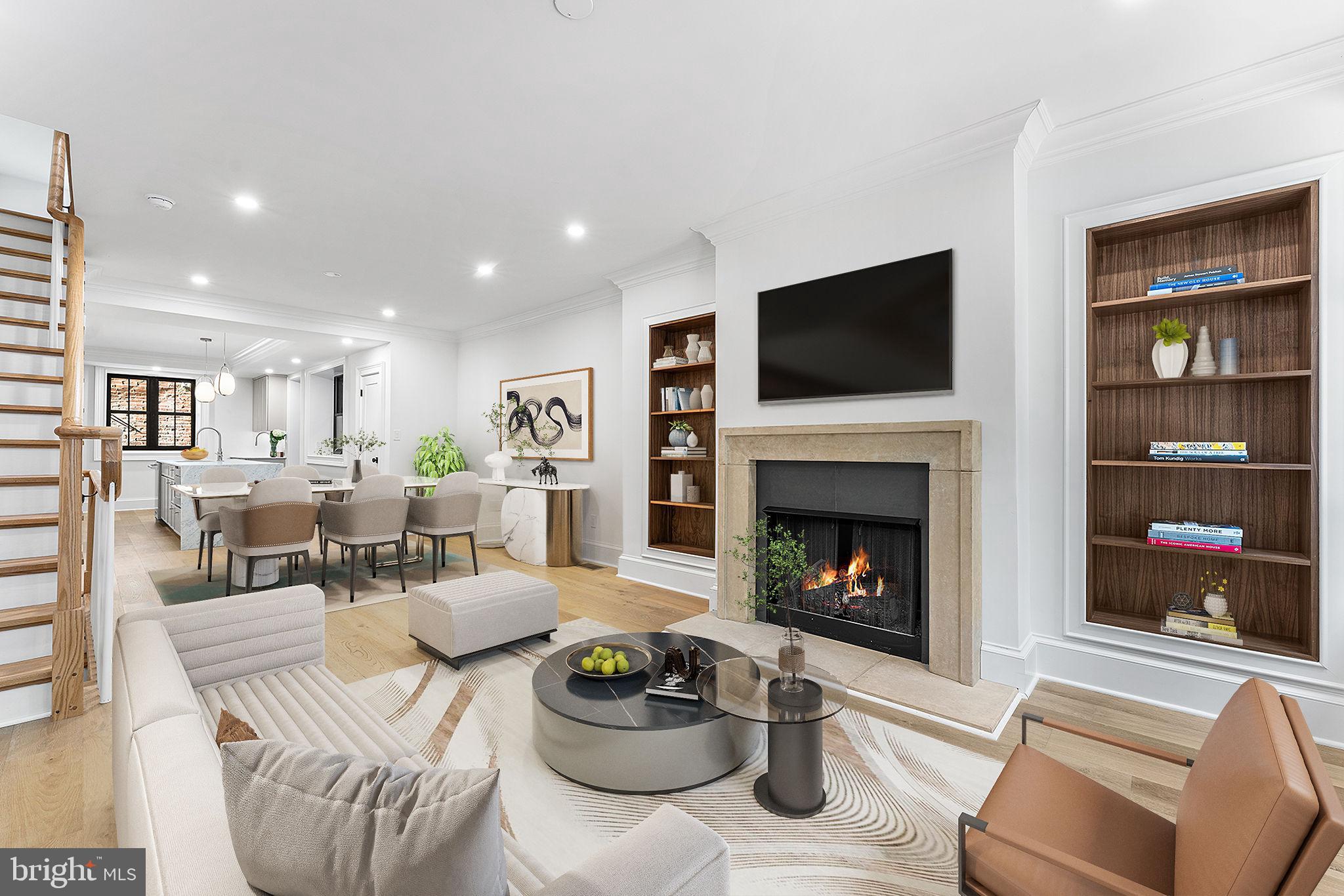 Stunning 4-bedroom, 3-bathroom, completely renovated townhome in the heart of Rittenhouse Square offers 2,444 square feet of luxurious city living, thoughtfully designed with high-end finishes and an open, light-filled layout. Step inside to find the stunning wide-plank hardwood floors and a seamless flow from the open living room—featuring elegant inset bookcases and a striking stone gas fireplace—through to the dining area and chef’s kitchen. The gourmet kitchen is a showstopper with a large waterfall island with seating, top-of-the-line appliances, and a built-in wet bar—perfect for entertaining. Custom Hunter Douglas remote control window treatments throughout. Upstairs, the serene primary suite features a vaulted ceiling, a spacious walk-in closet with a dressing area, and a spa-inspired en-suite luxury bathroom complete with a double vanity, a frameless glass shower, and a soaking tub. Three additional bedrooms share a stylish full hall bath with a tub. The finished lower level offers incredible flexibility as a family room or guest suite and includes a sleek third full bathroom with a walk-in shower. Cap it all off with a rooftop deck that delivers breathtaking panoramic views of the city skyline—ideal for relaxing or hosting guests. Located in the sought-after Greenfield School catchment and just steps to Rittenhouse Square, premier dining, shops, and beloved city parks. 10 year partial tax abatement. Luxury, space, and location—this gorgeous home truly has it all.