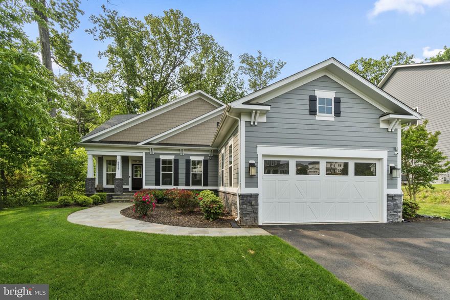 Tucked away on a wooded lot near Lake Barcroft, 6557 Brooks Place offers a perfect blend of town and country. Built in 2019, this handsome Craftsman features a modern floorplan with 5 bedrooms and 4 bathrooms spanning 3 levels and approximately 4,950 square feet. The main level provides open floorplan with double height ceilings spilling out onto a beautiful flagstone patio and tree lined backyard. On the main level is the generous primary suite with walk-in closet along with an additional bedroom home office with an en-suite bathroom. Upstairs, a large loft overlooks the main level and opens onto two bedrooms and a dual entry full bathroom. The lower level includes a massive family room with high ceilings and access to the backyard. Off the family room is an oversized guest bedroom suite with an en-suite dual entry bathroom and walk-in closet. Completing the lower level is a home gym and oversized storage room.