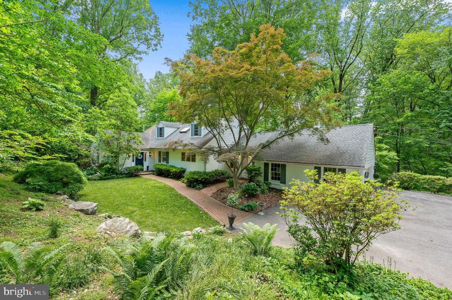 Welcome to “Timberbrook”, 512 Worthington Rd in Chester Springs.  One of the most unique, undeveloped pieces of land adjacent to Exton, this beautiful 8-acre property blends design, privacy and character. As you enter you are greeted by classic red brick floors and unique oak wood flooring, setting the tone for the warmth and charm throughout the home.  The recently renovated kitchen is truly a chef's dream, featuring a La Corneau induction range and high-end appliances.  The spacious quartz island with a striking wide-slab countertop is perfect for entertaining family and friends.  The adjacent dining room allows for seamless flow during gatherings, while the natural edge, walnut topped bar, complete with beverage/wine fridge and ice maker, enhances your entertaining experience.  Step out to the original stone patio, overlooking the beautiful scenery.  The living room is highlighted by a wood burning fireplace and large built-in cabinets that opens graciously into the kitchen.  The cozy den also features built-ins and a wood burning fireplace, making it an ideal spot for gamily games or a quiet night in winter. The main level features a first-floor Master bedroom with updated full bath and is a true oasis as you wake up each morning overlooking the beautiful park-like setting with a creek.  There is also a spacious guest bedroom with a recently updated full bath.  Upstairs you will find a private living space with two amazing bedrooms, full bathroom, and sitting area. The finished walk-out lower level has LVP flooring and lots of windows overlooking the creek and property. This lower level is another amazing space to entertain, watch games, or enjoy the nature outside.  The 8-acre property ranges over two townships (parcels 34-06 -0015 and 33-05 -0050.0100).  The home sits amongst a natural hollow of which the water flows through.  You will be delighted walking on stone paths to one of two walking bridges, accessing the other side of the land.  Around the corner, you will find “the beach”, where you are likely to spend many summers and autumns with a bonfire with friends.   Follow the path back and up to a  1.5-acre field, formerly used to raise lamb and feed sheep.  The field is bordered by paved walking paths in and around the neighboring properties.  Outside, you will also find a wonderful, fenced, raised garden boasting 5 beds and the quaintest front yard area.  Current owners have found many artifacts, if you enjoy gardening or being outside, there are not many properties left like Timberbrook.