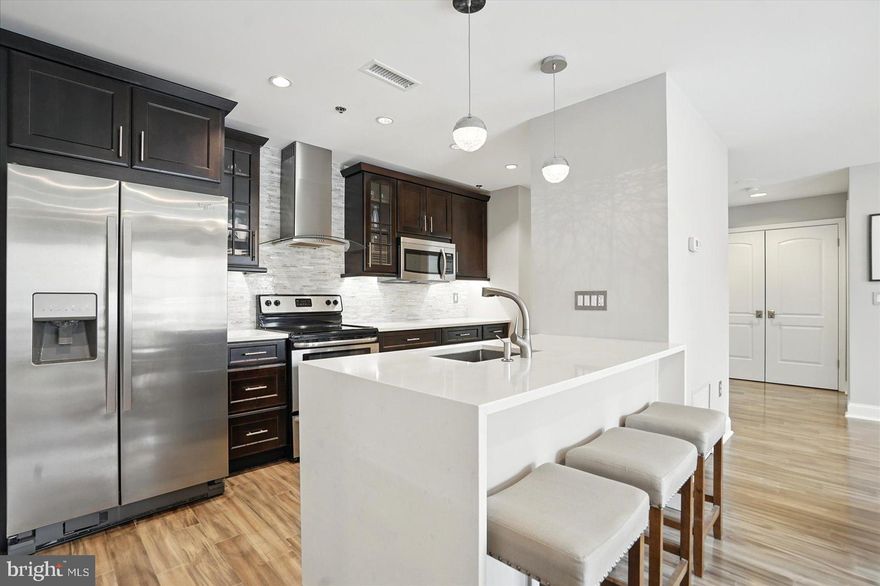 Looking for resort style living in the heart of Canton? This extremely sought-after gated condo community on the Canton waterfront is what you've been looking for! This gorgeous top floor unit features two bedrooms, two full baths and is filled with natural light, an open floor plan and ample outdoor space. Nearly every square inch of the unit has been meticulously updated, including beautiful quartz kitchen countertops with waterfall edge, under cabinet lighting, imported marble primary bath with custom glass enclosure, a custom stone fireplace in the living room, and more. Located within a short drive of local amenities as well as major arteries including I-95, 895 and 83. You are also within walking distance to some of Baltimore's best local restaurants, bars, grocery stores, athletic clubs, a swim club and shops which are located right outside your secure door. This stellar water-front building features a fitness center in the garage and 24-hour security. The unit comes with a deeded garage parking spot in addition to ample street parking. The unit also currently holds a second rental parking spot which the new owner could potentially take over for a monthly fee. Don't miss this one!