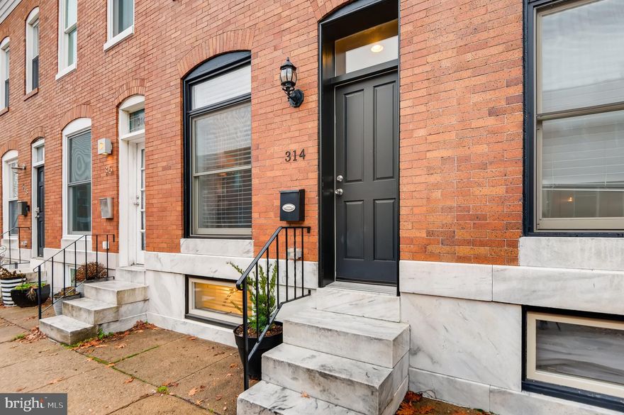 Gorgeous renovated row home close to Patterson Park featuring off-street parking, a rooftop deck with stunning city views, and a CHAP tax credit (approx 5 years remain)! Beautiful exposed brick and hardwood floors throughout, plus sophisticated crown molding and tray ceilings. The spacious kitchen features beautiful white cabinets, stainless steel appliances and granite counter tops. Two bedrooms and two full bathrooms boasting ceramic tile upstairs, and a third full bathroom on the lower level.  Enjoy city sunsets on the updated rooftop deck and never worry about parking with the covered car port in the rear!