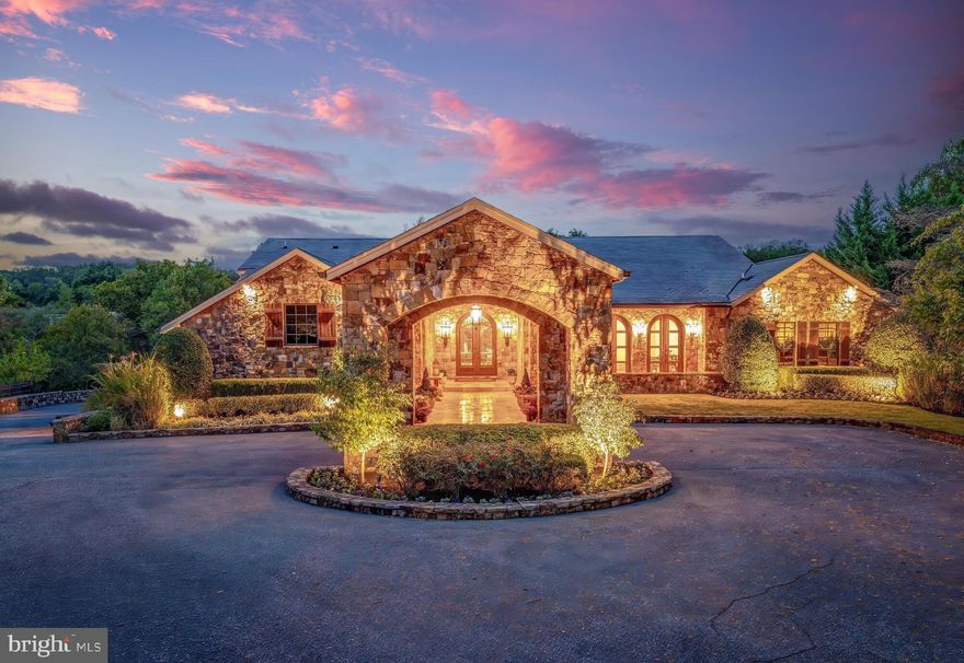 Nestled on over two private acres at the end of a cul-de-sac and backing to parkland, 2 Piney Meetinghouse Court is a masterfully reimagined estate that evokes the warmth and craftsmanship of the Tuscan countryside. This one-of-a-kind residence, renovated by RAD Construction, offers more than 12,800 square feet of finely curated living space across three expansive levels, featuring 6 bedrooms, 6 full baths, and 3 half baths.

From the moment you arrive, the property makes an unforgettable impression. A stone-clad covered Porte Cochere with custom designed front door and circular driveway, set the tone for the elevated interiors that follow. Inside, the impressive grand Foyer and Gallery with 17-foot ceilings introduce an open floor plan designed for both elegant entertaining and effortless everyday living.

The main level offers a sophisticated Dining Room with wood beams and a gracious sun-filled Living Room opening to a spacious stone Terrace with views of the estate grounds and a wood-burning fireplace. Adjacent to the Living Room is a Tasting Room with a glass enclosed, temperature-controlled Wine Room, accommodating 1300 bottles. 

At the heart of the residence is the stunning gourmet chef’s Kitchen open to the Family Room, featuring 19-foot ceilings and architectural wood beams, an awe-inspiring space and true centerpiece of the home. The Kitchen is outfitted with top-tier appliances, bespoke cabinetry, and an oversized island perfect for gatherings. The kitchen flows seamlessly into an impressive Family Room. Rich hardwood floors, designer lighting, iron accents and refined finishes enhance every corner.

A separate wing of the main level features the Primary Suite which serves as a serene retreat, complete with a spa-inspired Bath and a custom oversized Dressing Room. An additional Bedroom Suite, a private Study or Home Office, a Powder Room and Mudroom complete the main level.

Upstairs, three beautifully appointed bedrooms and two Full Baths provide comfort and privacy. The walkout Lower Level transforms into an entertainer’s haven, featuring a home theater, a fully equipped fitness room, a sixth Bedroom and adjacent Full Bath, a Recreation Room and Lounge with a built-in Bar and a dedicated Arts and Crafts Studio.

Outside, an exceptional private oasis awaits. A resort-style freeform Pool with built-in Spa, expansive covered and uncovered stone terraces with firepit, and a lighted Sport Court are all framed by mature trees and meticulous landscaping. An enclosed pool house, complete with a full Kitchen, and a separate Dressing Room, and sixth Full Bath, offer seamless support for outdoor living and entertaining.

A rare fusion of Italian inspiration and East Coast sophistication, this estate is a true standout for those seeking an elevated and extraordinary lifestyle.