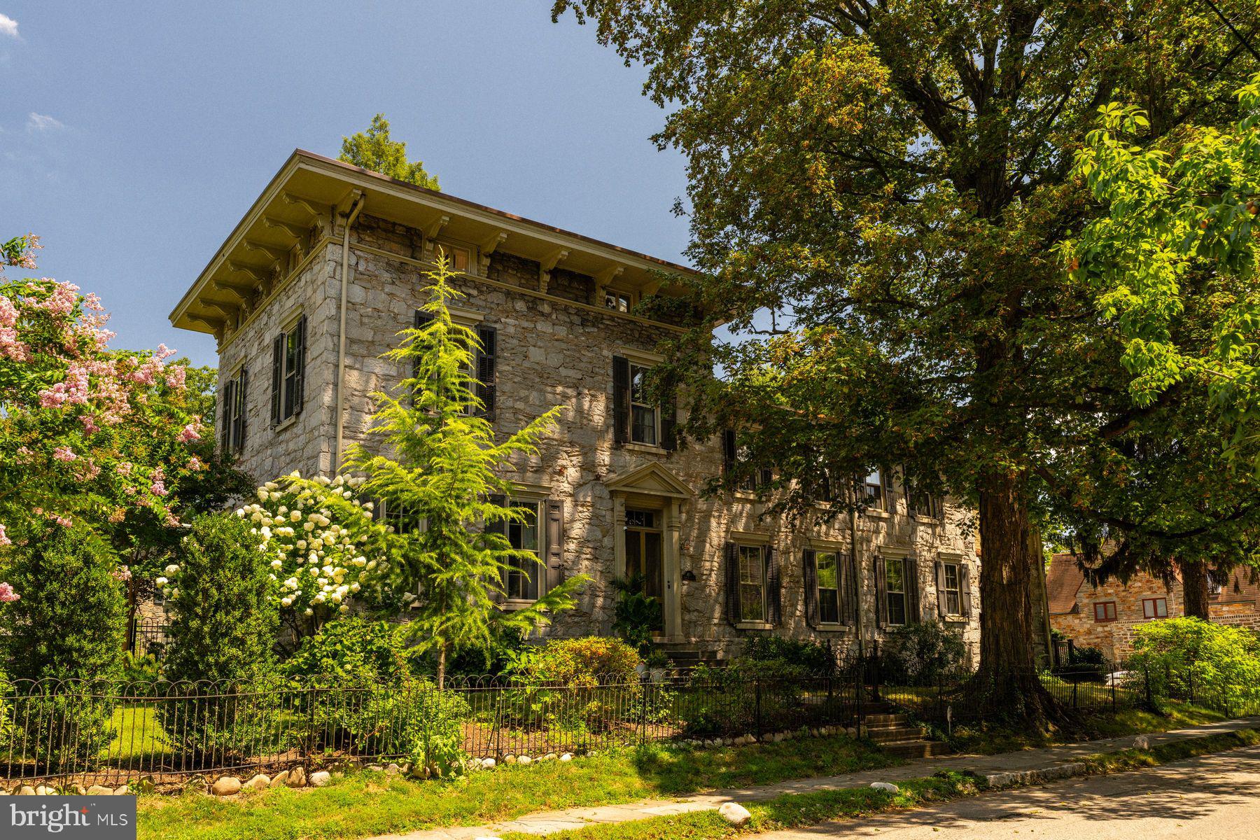 Step inside this exceptional 1860s stone Italianate residence, a rare Chestnut Hill offering that balances historic grace with more than $1.5 million in thoughtful renovations.  World-renowned architectural  firm Kieran Timberlake — alongside Philadelphia historic renovation experts Rasmussen/Su — have  successfully married timeless architecture with sleek modern function and performance. Every detail was thoughtfully considered, and every material chosen for integrity, beauty and contemporary living, creating a home that is elegant, timeless, and enduring.
From the soaring eleven-foot ceilings to the handcrafted plaster and limewash walls, the interiors speak to an enduring refinement, while extensive updates provide modern comfort. The main level opens with a dramatic foyer leading to a grand living room with oversized windows, built-ins, and a fireplace. The flowing design allows sightlines from the living room through the foyer into the dining room, where expertly restored French doors connect to both enclosed and open porches and a fabulous outdoor living experience.  The custom kitchen pairs timeless details with high-performance features, including soapstone counters, a Wolf range, Sub-Zero refrigerator, and the original pantry. A classic mudroom, laundry area, and back staircase complete the level, while the basement provides workspace and significant storage.
Upstairs, the primary suite is a reimagined retreat featuring a custom arched doorway that echoes the second-floor landing and arched hallway, creating architectural harmony throughout. The suite includes a serene sitting area, walk-in closet, and en-suite bath with a steam shower, heated flooring, hidden storage, and handcrafted cabinetry. Quarter-sawn oak floors lend warmth underfoot. Three additional bedrooms line the dramatic hallway, while the third floor offers one more bedroom, two additional rooms for work/play activity, three closets including a large walk-in, and a newly designed bath with a six-foot soaking tub and tiled shower.
Anchored by a coveted Hartley Botanic English greenhouse, oversized porcelain paver patios, and lush gardens, the transformed grounds offer a superb, seamless indoor-outdoor experience.  Entertain, relax, connect to nature. Â
With a new roof, updated plumbing, gas hot water heating, converted radiators, and whole-house A/C, the home blends 19th-century architecture with 21st-century comfort. Just blocks from the shops and restaurants of Chestnut Hill and moments from the Wissahickon trails and train, this residence is both a historic treasure and a modern masterpiece.