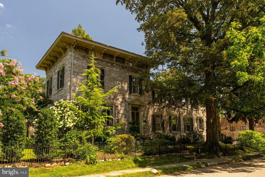 Step inside this exceptional 1860s stone Italianate residence, a rare Chestnut Hill offering that balances historic grace with more than $1.5 million in thoughtful renovations.  World-renowned architectural  firm Kieran Timberlake — alongside Philadelphia historic renovation experts Rasmussen/Su — have  successfully married timeless architecture with sleek modern function and performance. Every detail was thoughtfully considered, and every material chosen for integrity, beauty and contemporary living, creating a home that is elegant, timeless, and enduring.

From the soaring eleven-foot ceilings to the handcrafted plaster and limewash walls, the interiors speak to an enduring refinement, while extensive updates provide modern comfort. The main level opens with a dramatic foyer leading to a grand living room with oversized windows, built-ins, and a fireplace. The flowing design allows sightlines from the living room through the foyer into the dining room, where expertly restored French doors connect to both enclosed and open porches and a fabulous outdoor living experience.  The custom kitchen pairs timeless details with high-performance features, including soapstone counters, a Wolf range, Sub-Zero refrigerator, and the original pantry. A classic mudroom, laundry area, and back staircase complete the level, while the basement provides workspace and significant storage. 

Upstairs, the primary suite is a reimagined retreat featuring a custom arched doorway that echoes the second-floor landing and arched hallway, creating architectural harmony throughout. The suite includes a serene sitting area, walk-in closet, and en-suite bath with a steam shower, heated flooring, hidden storage, and handcrafted cabinetry. Quarter-sawn oak floors lend warmth underfoot. Three additional bedrooms line the dramatic hallway, while the third floor offers one more bedroom, two additional rooms for work/play activity, three closets including a large walk-in,  and a newly designed bath with a six-foot soaking tub and tiled shower.

Anchored by a coveted Hartley Botanic English greenhouse, oversized porcelain paver patios, and lush gardens, the transformed grounds offer a superb, seamless indoor-outdoor experience.  Entertain, relax, connect to nature.  

With a new roof, updated plumbing, gas hot water heating, converted radiators, and whole-house A/C, the home blends 19th-century architecture with 21st-century comfort. Just blocks from the shops and restaurants of Chestnut Hill and moments from the Wissahickon trails and train, this residence is both a historic treasure and a modern masterpiece.