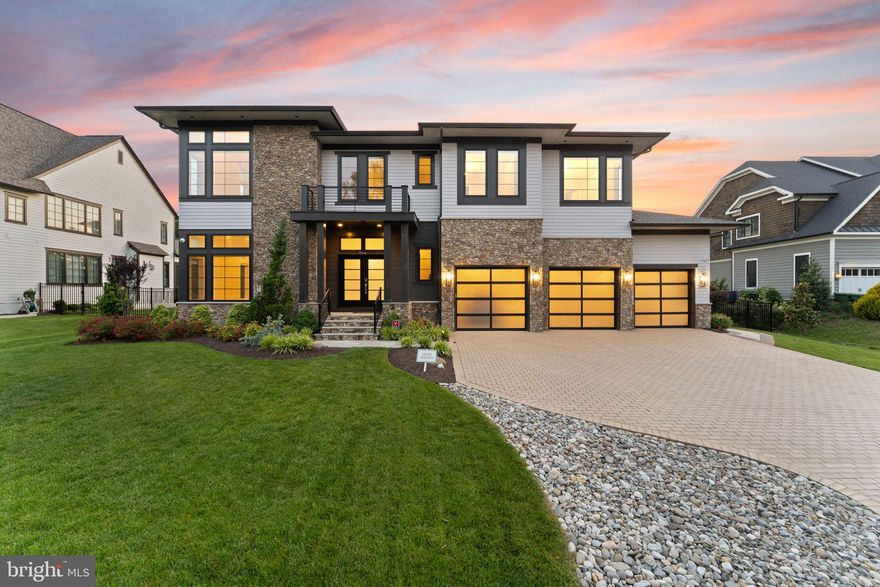 Enjoy the ideal balance of location, convenience, and tranquil indoor-outdoor luxury at this practically new contemporary home built in 2021, gently lived in with no pets, and perfectly situated in the heart of McLean. Set on a generous 0.33-acre lot designed by a landscape architect, the property offers a park-like setting with elegant evening lighting, an expansive deck with retractable awning, and abundant space ready for your outdoor kitchen or grill. Complete with a Hydro-Tech irrigation system and sleek black metal fencing, this is the perfect low-maintenance outdoor retreat. The exterior features high quality James Hardie siding, stone accents, Anderson windows, and an attractive paver driveway. Inside, the home features a flexible open layout designed for the way you live, with a private elevator for effortless access between all three levels. A large formal foyer welcomes you with a walk-in coat closet, powder bath, and the first light-filled living area. The heart of the home is an expansive open great room, where an oversized island with two Cove premium dishwashers and beautiful backyard views anchors a chef-inspired kitchen equipped with Viking range, SubZero refrigerator, and Wolf under-counter microwave. Enjoy versatility for gatherings or relaxed everyday living with multiple dining options at the island, adjoining breakfast nook, and formal dining area, all flowing seamlessly into the spacious family room highlighted by a contemporary fireplace. Additional conveniences include a home office overlooking lush landscaping, and a mudroom with walk-in pantry, oversized closet, and a practical drop zone and charging station. The upper level provides luxurious comfort, led by the impressive primary suite featuring a private balcony and a spa-like bath with an oversized, no-step shower. Three additional ensuite bedrooms offer private personal space for everyone, including one equipped with custom built-in storage. Laundry with LG front-loaders is thoughtfully located near the bedrooms, and an inviting loft complete with beverage cooler and sink provides another space for gatherings, homework, or quiet mornings. The lower level provides more versatile lifestyle spaces, featuring a dedicated fitness room with mirrored wall, a fifth bedroom with adjoining bath, and a second office perfect for working from home or as a wine room. Enjoy entertaining and relaxing in the spacious media/theatre room or around the deluxe wet bar, complete with Fisher & Paykel refrigerator, dishwasher, microwave, and upgraded cabinetry and countertops. Walk-up French doors secured with a keypad provide private patio access and independent entry. The oversized three-car garage includes epoxy flooring, upgraded lighting, translucent doors for natural light, and an electric vehicle charging hookup. Pre-wired for solar and HOA-approved for solar installation, this home is future-ready. With easy pedestrian access to McLean’s downtown area, you'll find popular restaurants, local shops and conveniences, and Lewinsville Park all just a few blocks away, as well as close proximity to top-rated Fairfax schools and major commuter routes. This thoughtfully designed home offers the perfect blend of modern luxury and everyday functionality in one of McLean's most exceptional locations.