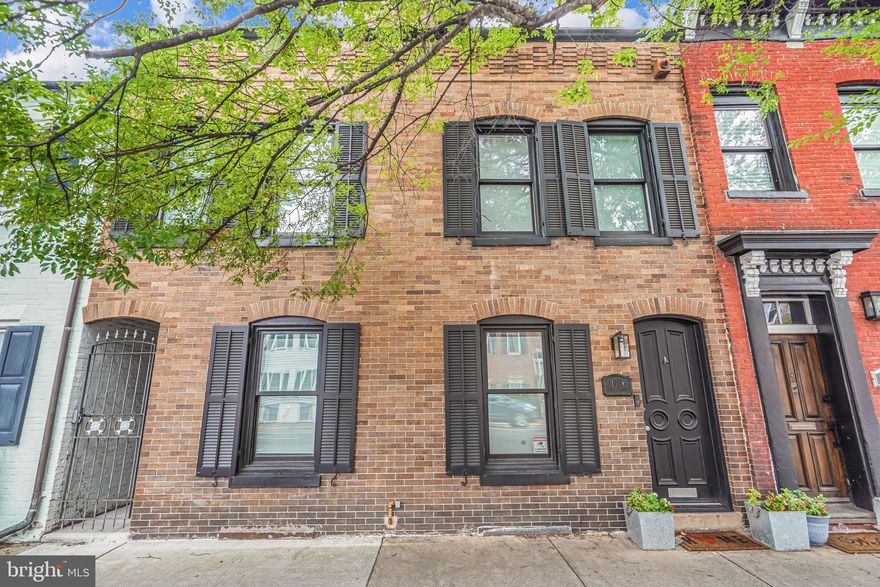 Originally built in 1900, this exceptional row house was completely transformed in 2021 with a thoughtfully designed three-level addition that seamlessly blends historic charm with sophisticated modern living. The stunning gourmet kitchen is the centerpiece of the home, featuring tall custom cabinetry, an oversized center island, elegant marble countertops, porcelain tile flooring, a Sub-Zero refrigerator,  Cove dishwasher, Capital pro-style  range with  pot filler faucet, and premium finishes throughout.

The open-concept main level was designed for both everyday living and entertaining, offering spacious dining, family, and living areas anchored by a stylish wood-burning fireplace. Every detail of this remarkable renovation was carefully curated to provide the new owner with luxury, comfort, and timeless design.

The upper level features two luxurious ensuite bedrooms, including a spectacular primary suite complete with a walk-in closet enhanced by clerestory windows that create breathtaking nighttime views and an abundance of natural light. Both spa-inspired bathrooms are stunningly designed with frameless glass showers, high-end porcelain tile, elegant fixtures, and sophisticated finishes that deliver a true luxury retreat experience. For added convenience, the laundry area is also thoughtfully located on this level.

The refined lower level offers exceptional versatility and comfort, complete with a separate exterior entrance. This beautifully finished space showcases an exposed original brick wall that adds warmth and character, along with a spacious third bedroom and full bath. A large recreation area provides the perfect setting for relaxing, TV watching, entertaining guests, or creating a private retreat for visitors or extended stays.

ADDITIONAL HIGHLIGHTS: Two-car parking pad in Mackley Alley; ALL NEW as of 2021: plumbing and electrical, roof, HVAC & tankless water heater, energy efficient windows. Power lines and cable lines have been buried. Gas line has been run to rear patio for a gas grill.

GREAT VRBO potential!!